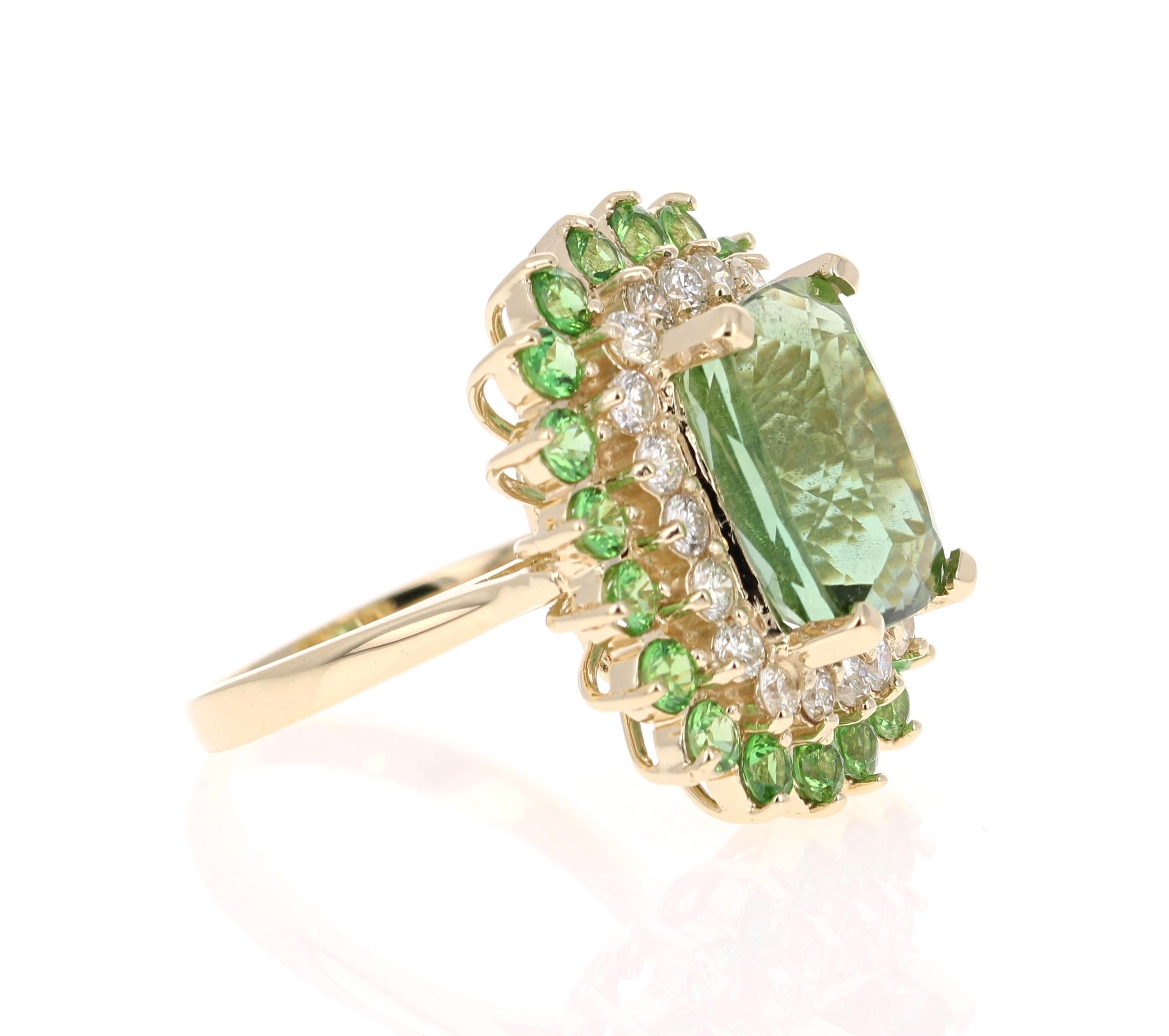A unique beauty that is sure to be a rare and gorgeous design! 

This stunner has a gorgeous Rectangular/Cushion Cut leafy Green Tourmaline that weighs 7.90 Carats. Surrounding the Tourmaline are 20 Round Cut Diamonds that weigh 0.90 Carats with a