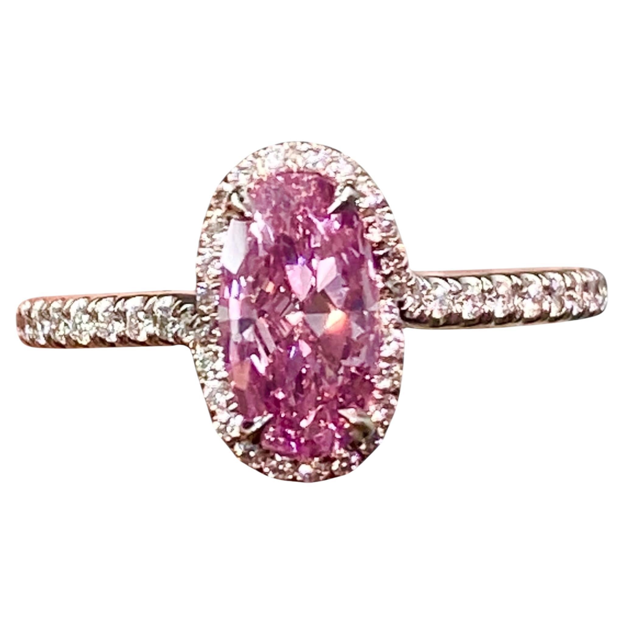 This exceptional 1.04-carat Fancy Vivid Purple-Pink diamond is truly one of a kind—there is no other diamond like it on Earth. GIA-certified and masterfully cut in a brilliant oval shape, this rare gem exhibits an intense, saturated hue that is both