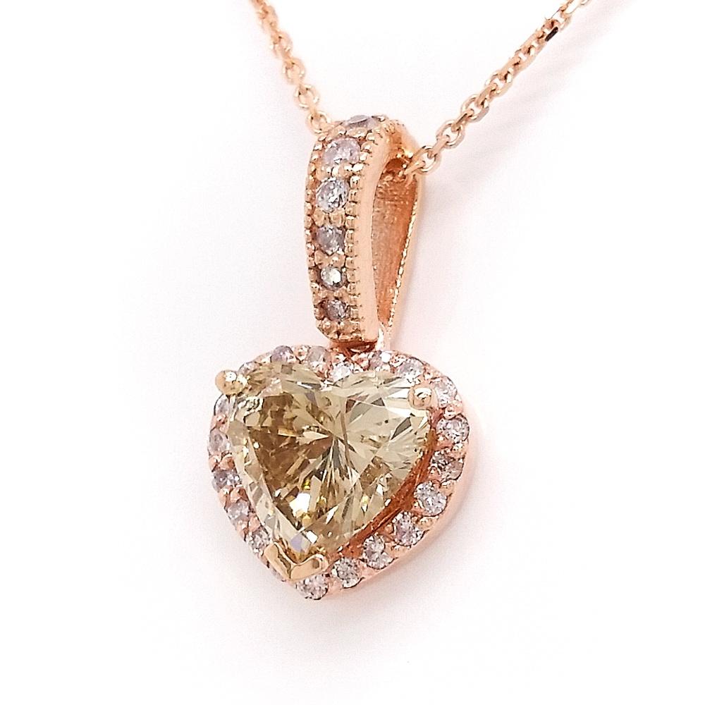 Love is in the air with this cute 14kt pink gold pendant featuring a gorgeous heart-shaped 1.04 carats fancy yellowish brown diamond surrounded by 26 round brilliant link pink diamonds. This warm color combination will immediately win your heart.