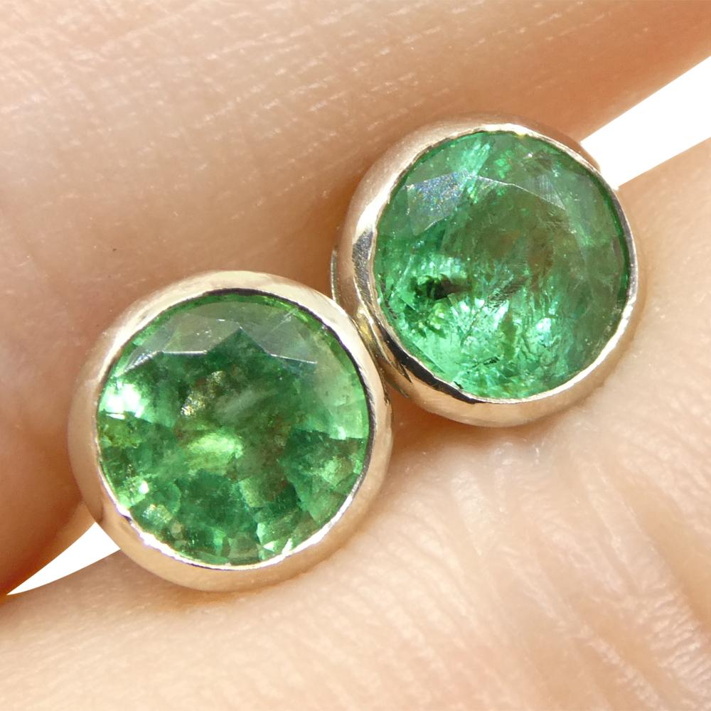 Elevate your elegance with these exquisite 1.04 ct Round Green Emerald Stud Earrings, masterfully bezel set in 14k White Gold. Perfectly designed for the discerning individual, these earrings encapsulate timeless beauty and