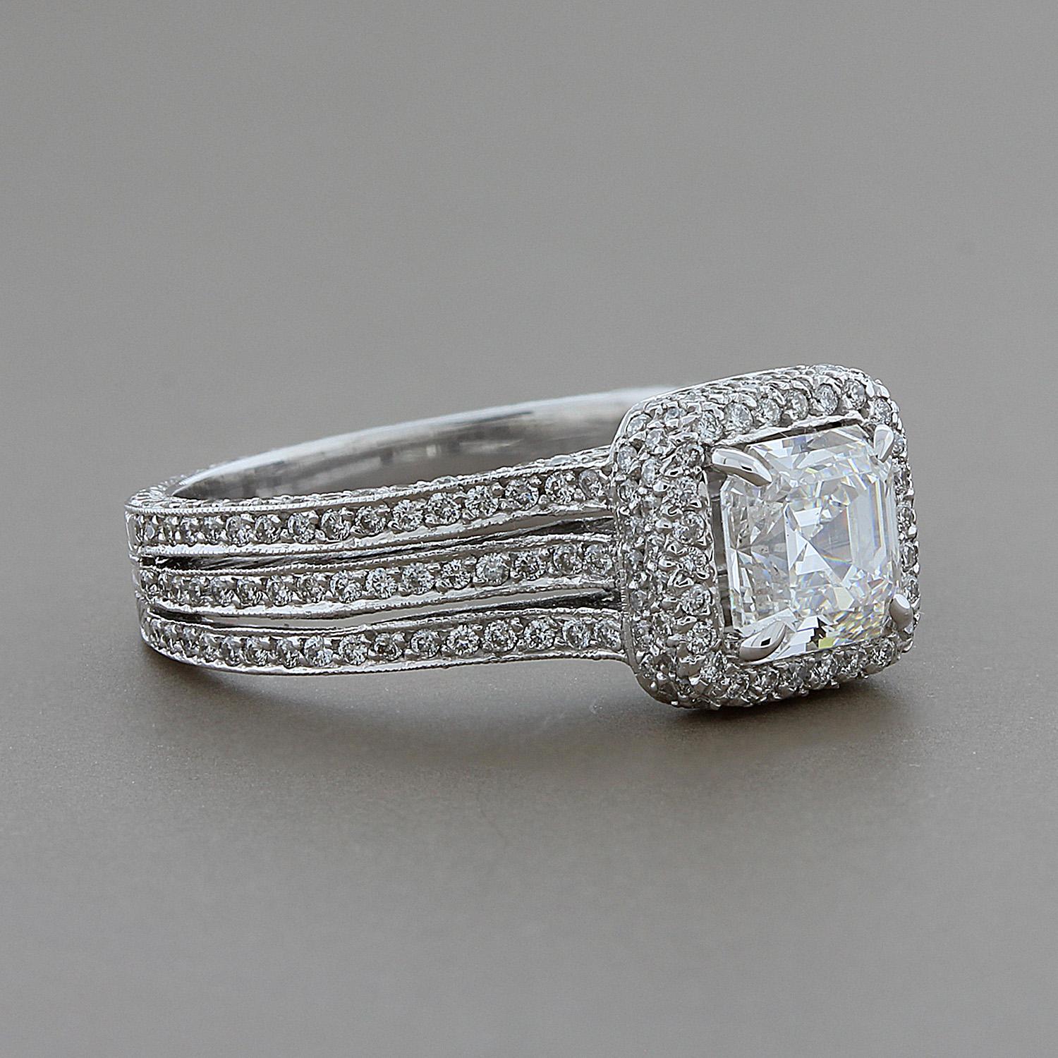 A contemporary engagement ring featuring a 1.05 carat asscher cut diamond with a GIA certified G color and VS1 clarity. The diamond is haloed by 0.86 carats of VVS diamonds that are set down to the triple shank that leads to beautiful gold filigree