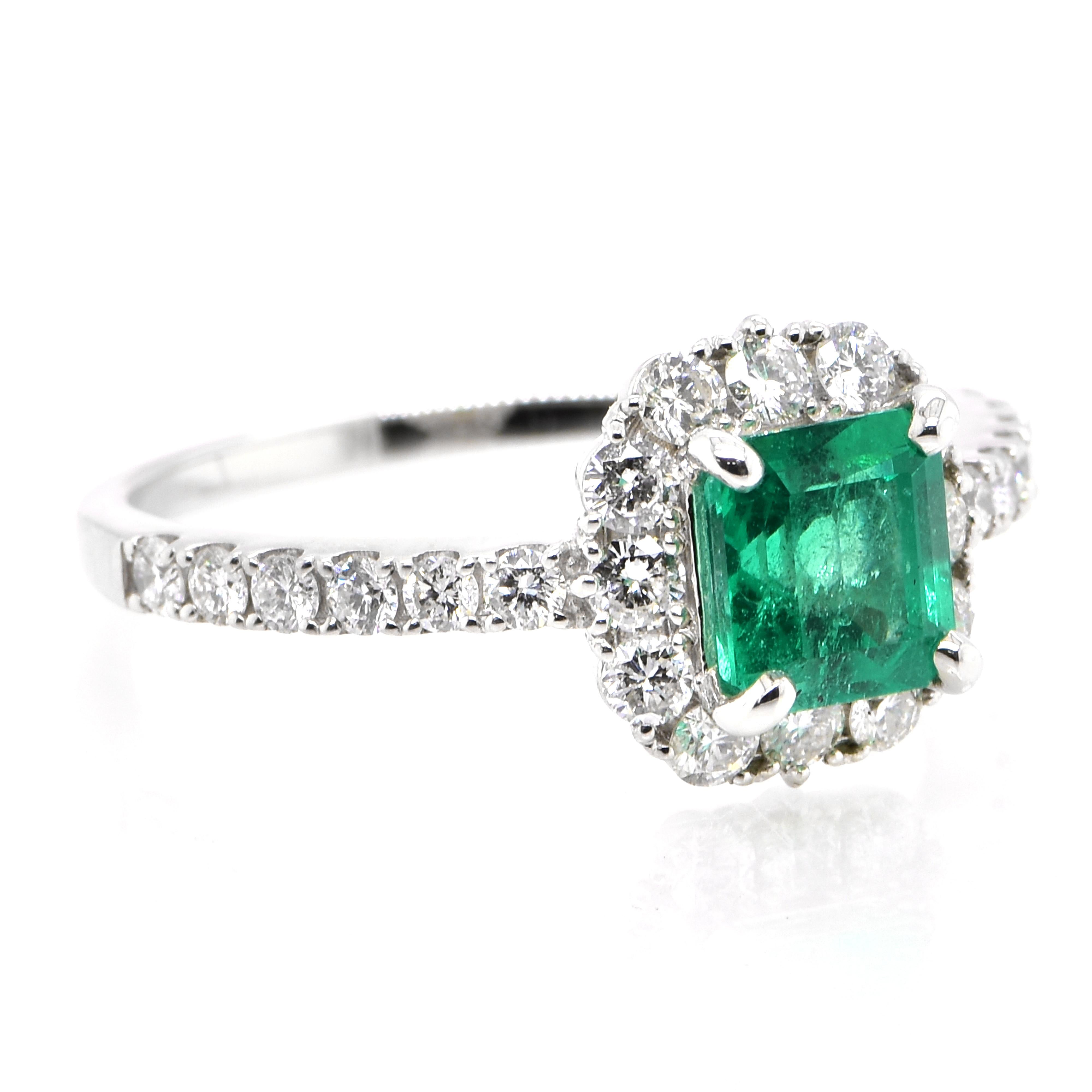 Modern 1.05 Carat Natural Colombian Emerald and Diamond Halo Ring set in Platinum For Sale
