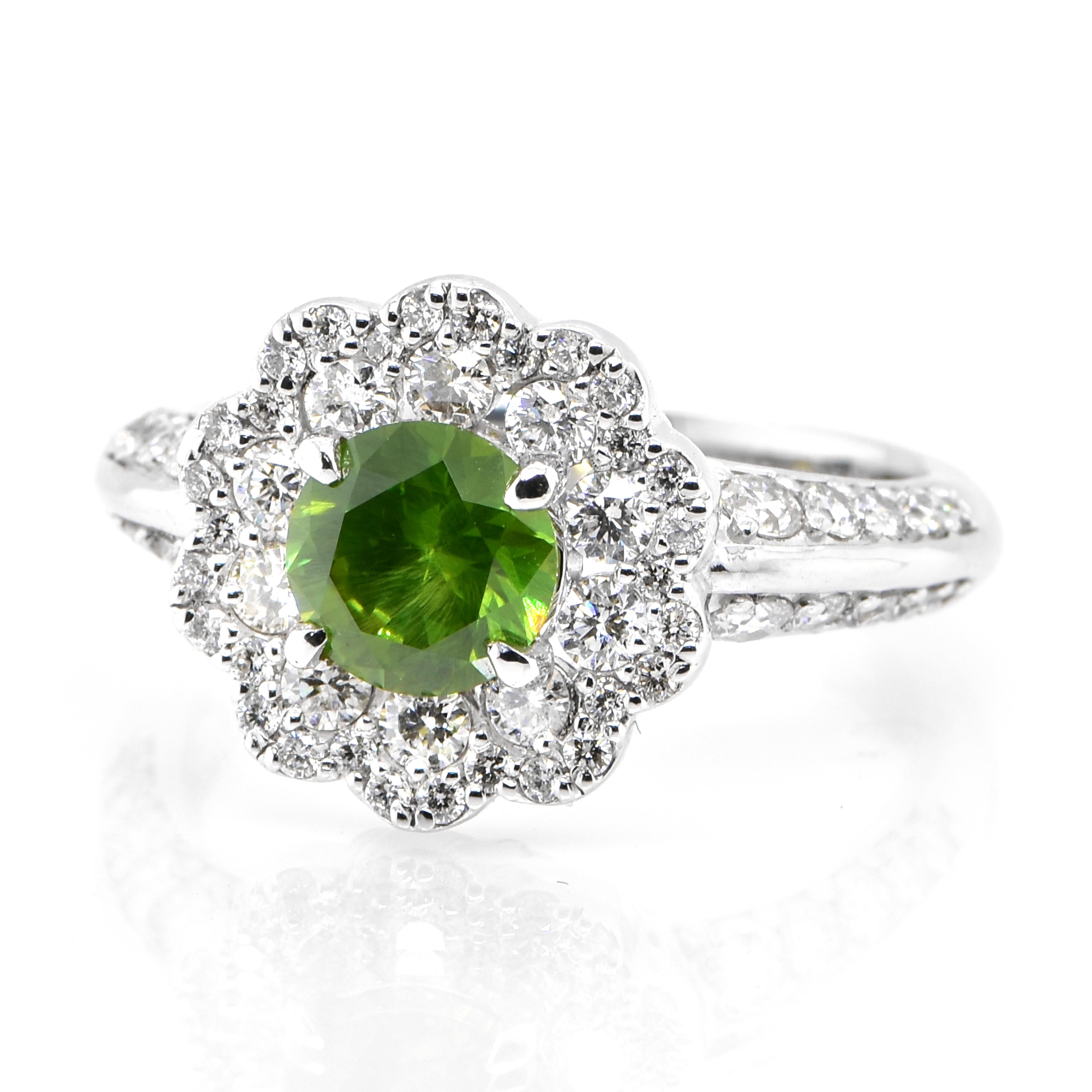 A beautiful cluster ring featuring a 1.05 Carat, Natural Demantoid Garnet and 0.84 Carats of Diamond Accents set in Platinum. Demantoid Garnet's only known source used to be the Ural Mountains in Russia however recent discoveries in Africa have