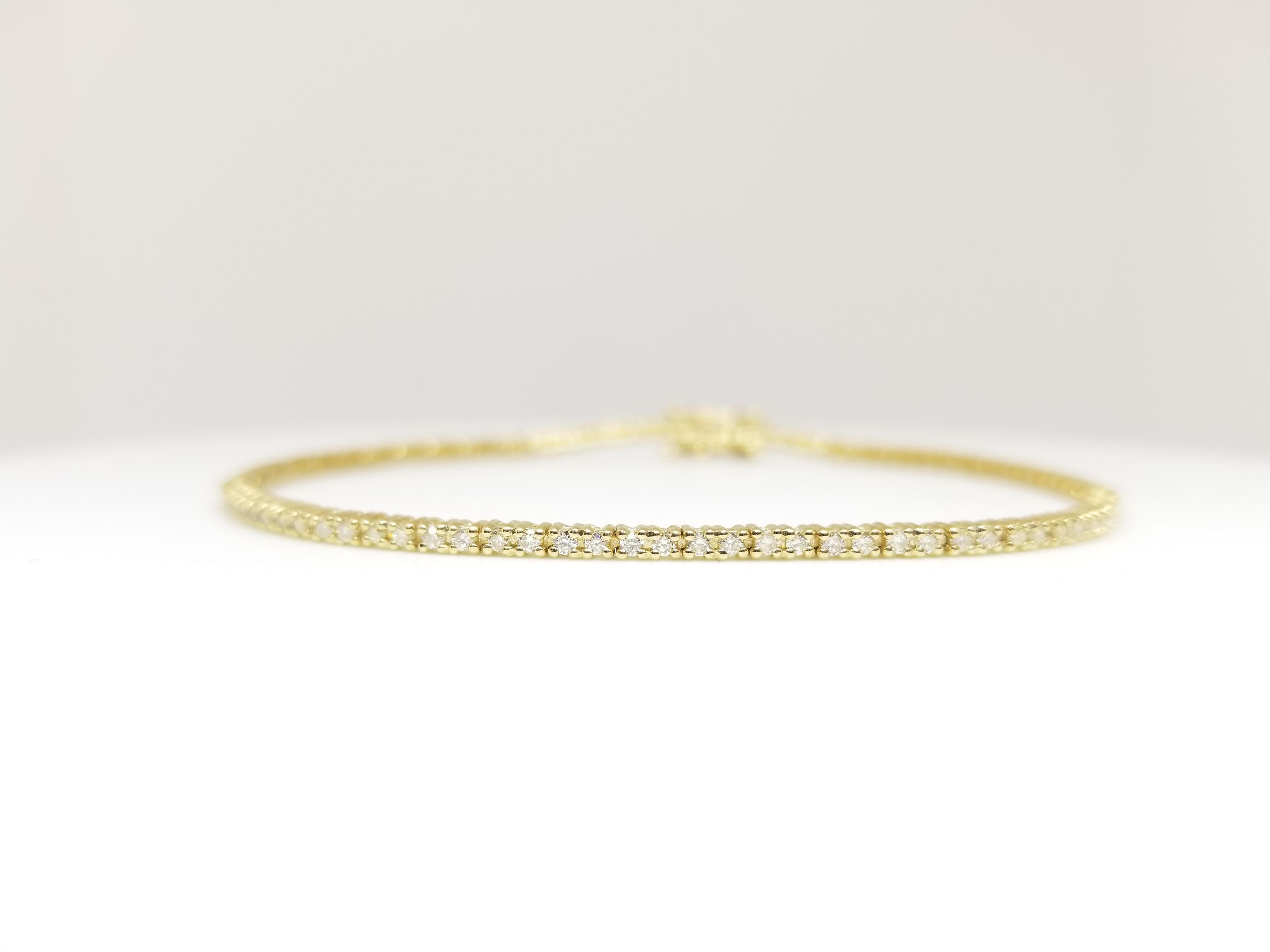 A quality tennis bracelet, containing 102 pcs of round-brilliant cut diamonds. set on 14k yellow gold. each stone is set in a classic four-prong style for maximum light brilliance. 7 inch length. Color I-J, Clarity SI3-I1.