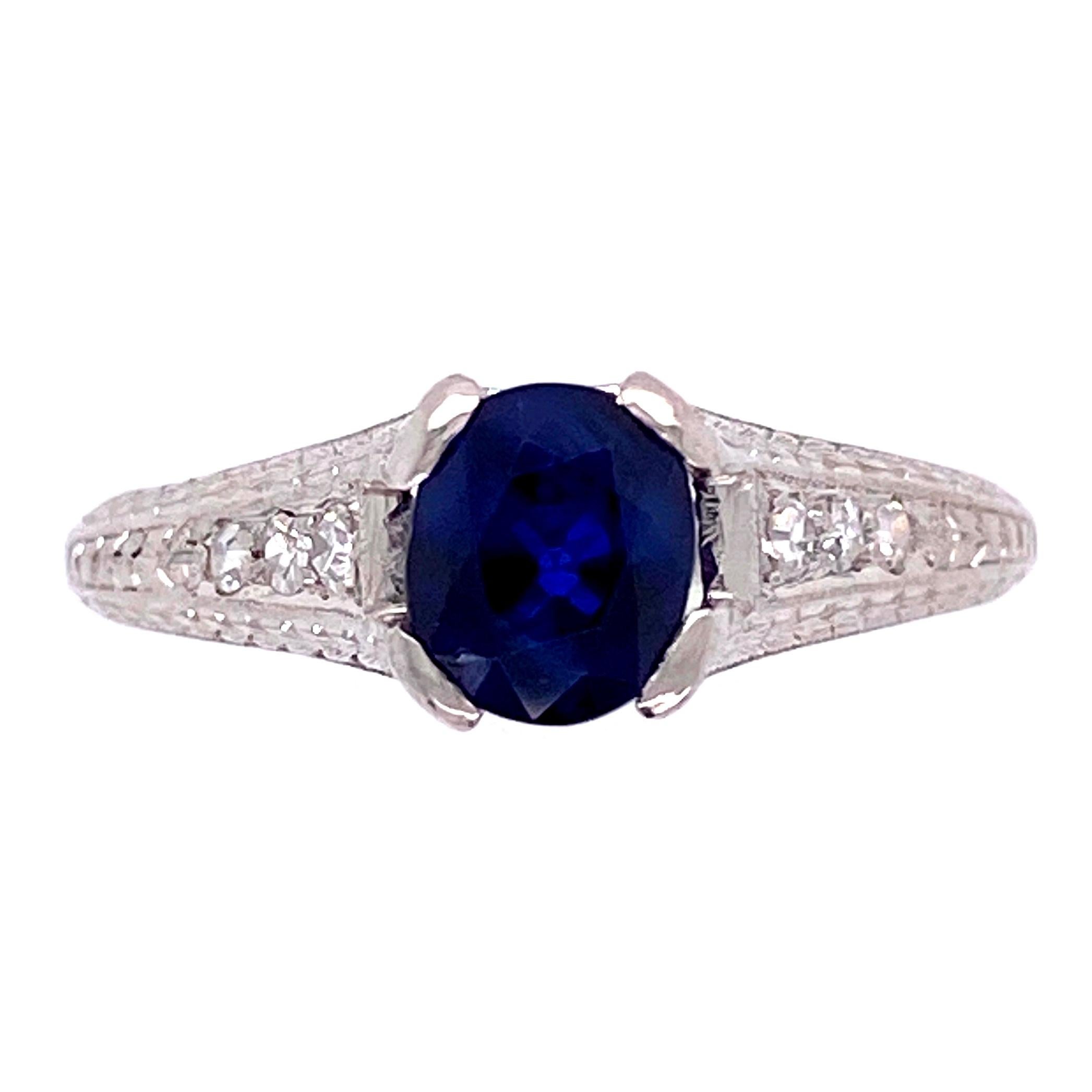 Simply Beautiful! Classic and finely detailed Blue Sapphire Ring, center securely set with a 1.05 Carat Blue Sapphire, accented by Diamonds. Hand crafted Platinum mounting. Engraving and milgrain adorn this Beautiful ring. Ring size 5.25. The