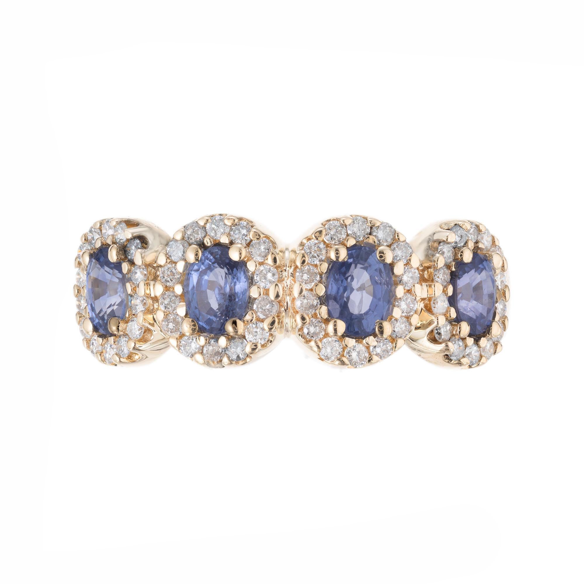 4 oval sapphire and diamond halo 14k yellow gold band ring.  Each oval sapphire is surrounded by a halo of round cut diamonds. 

Four 4 x 3mm oval Sapphire, approx. total weight 1.05cts
56 full cut diamonds, approx. total weight .44cts, I, SI
Size 7