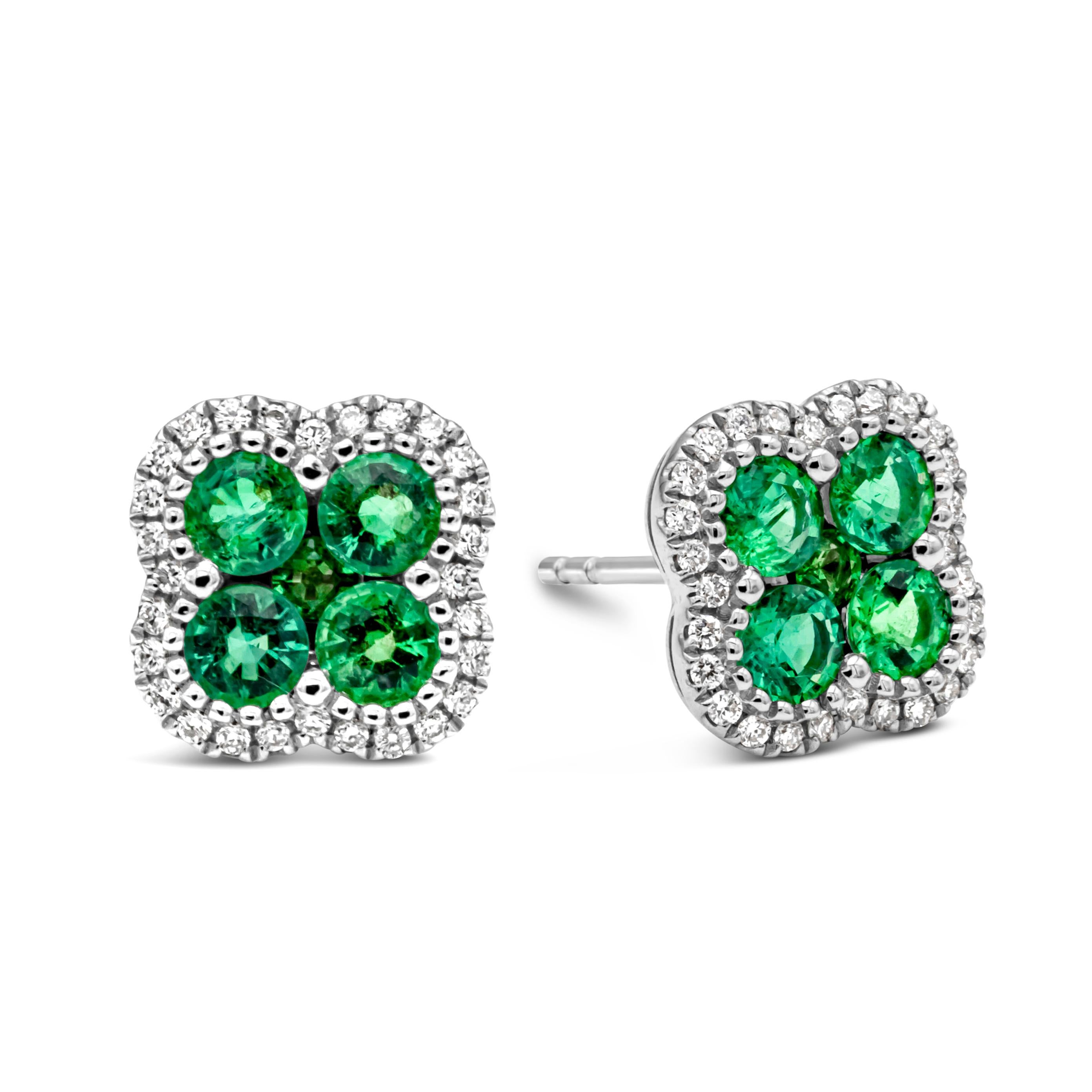 A simple and chic pair of stud earrings showcasing a cluster of round brilliant Colombian green emeralds weighing 1.05 carats total, arranged in a beautiful clover design and shared prong setting. Surrounded by a single row of round brilliant