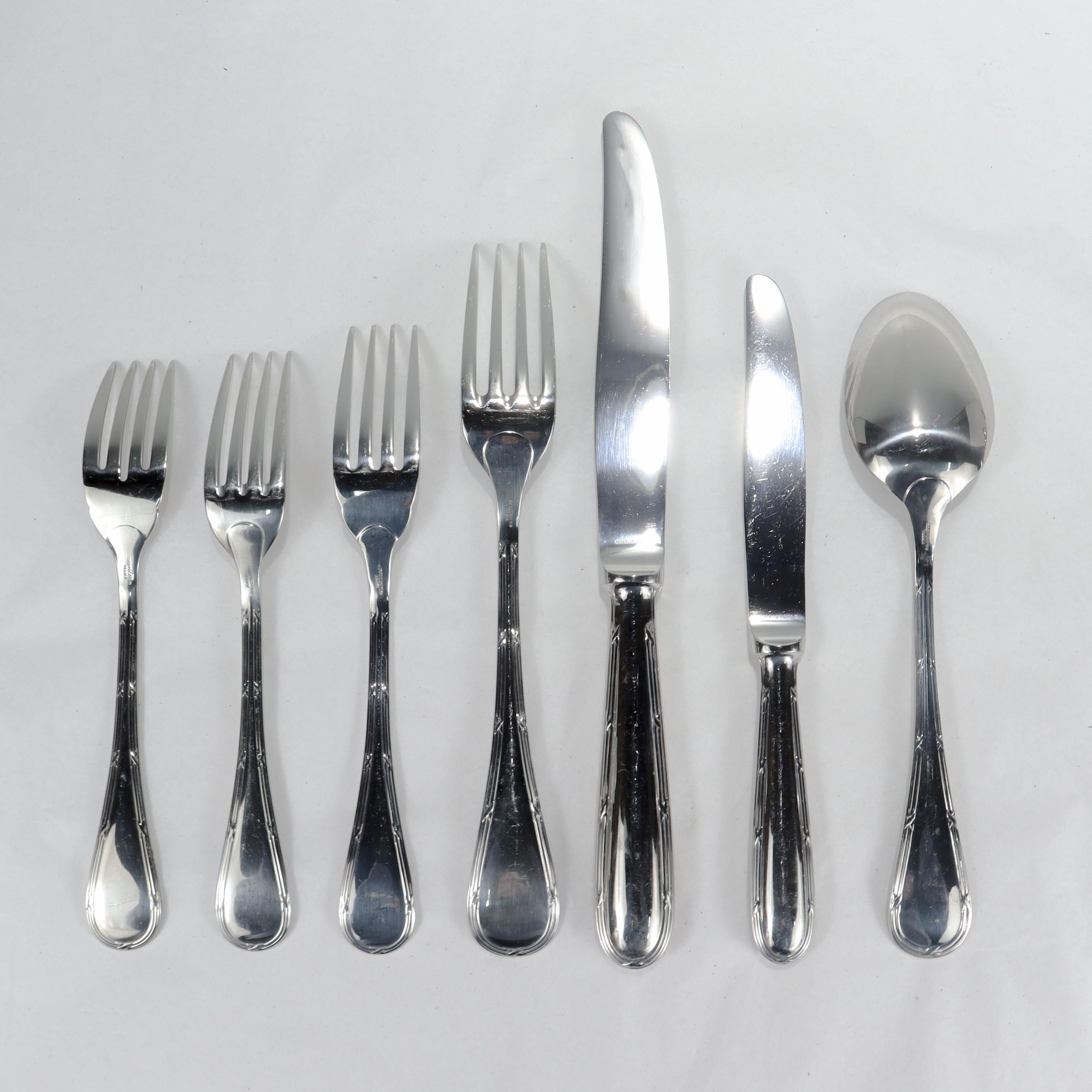 A very fine stainless steel flatware set.

By Christofle in their Capricorne line.

In the Pastorale pattern.

Consisting of:
12 Forks (8 1/4