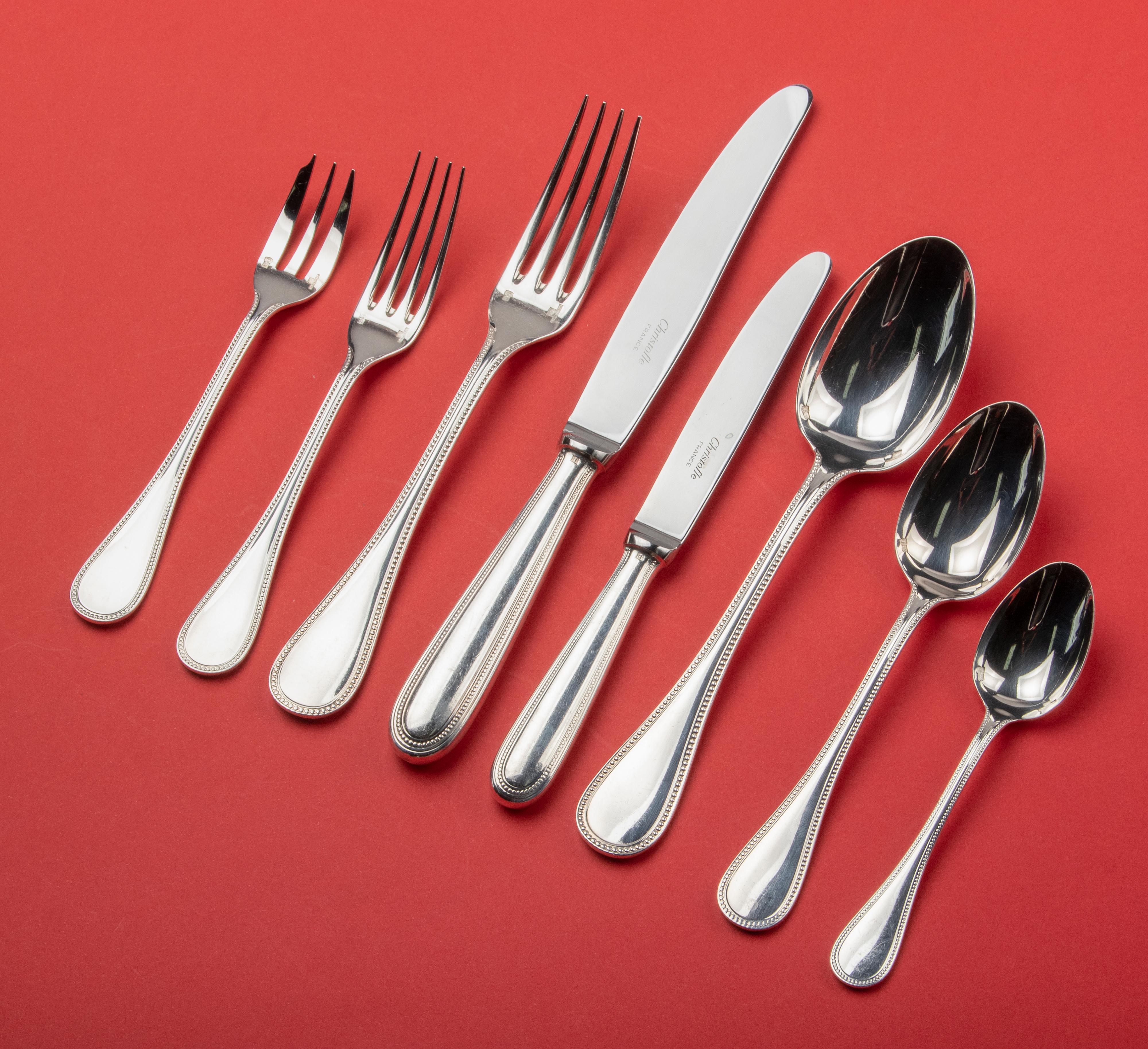 Beautiful set of silver-plated table cutlery in original box by the French brand Christofle. The model is Perles. This timeless and classic pattern will suit any table setting. The cutlery is composed as follows: 12 table knives, 12 table forks, 12