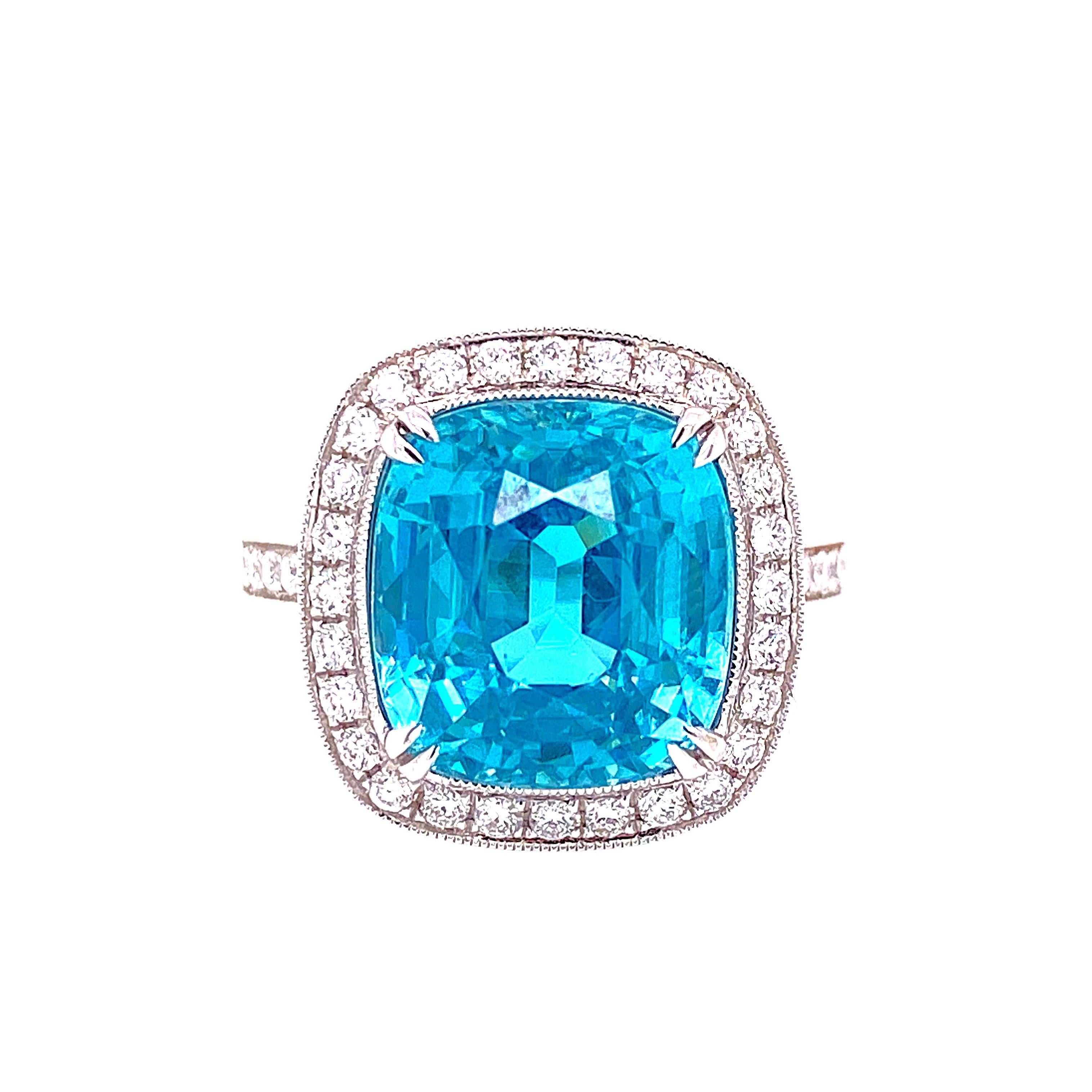 This stunning Cocktail Ring features a beautiful 10.50 Carat Cushion Blue Zircon with a Diamond Halo, on a Diamond Shank. This ring is set in 18K White Gold. Total Diamond Weight = 0.47 carats. Ring Size is 6 1/2.