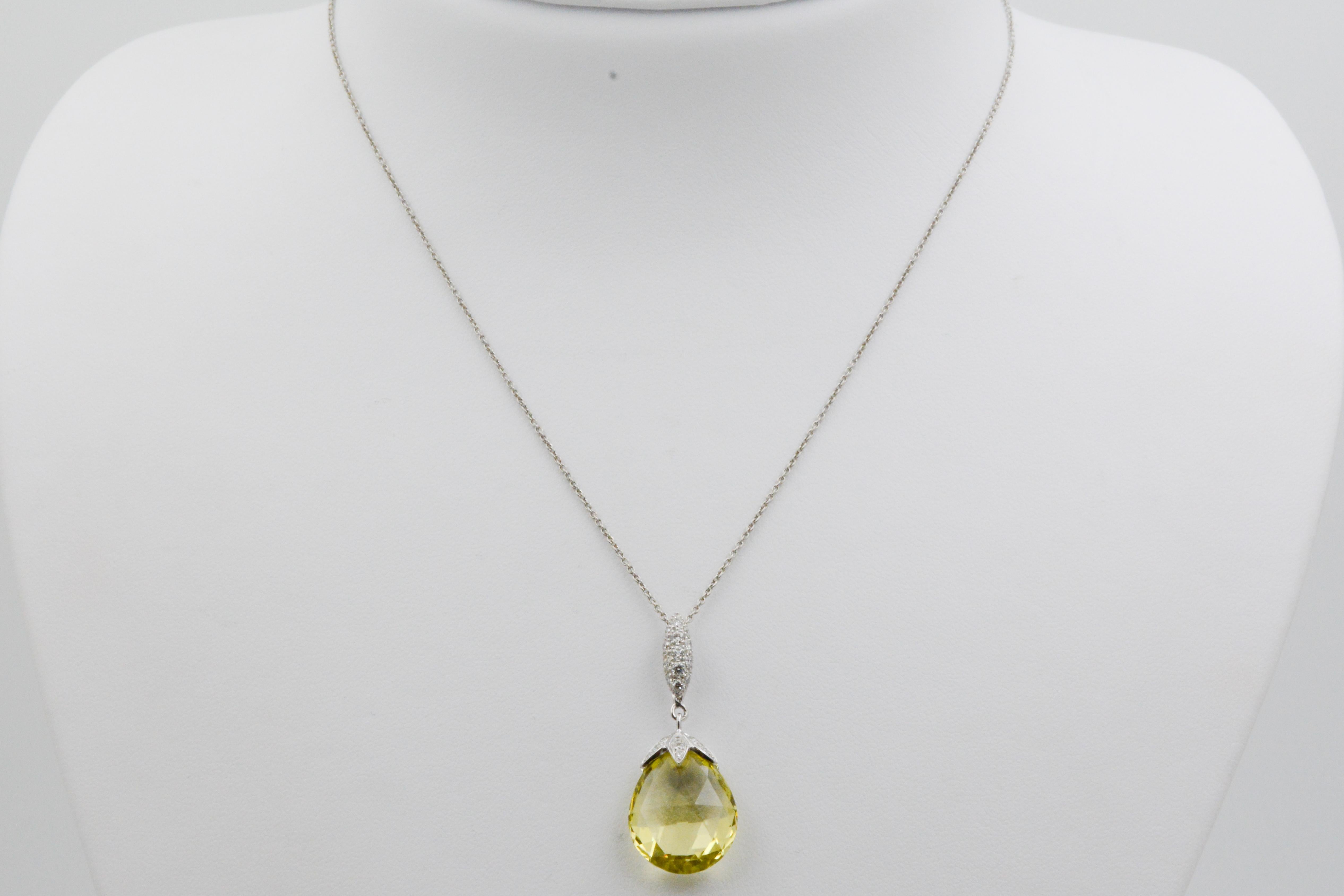 This pendant features a 10.50 carat total weight Lemon Quartz Briolette dangling from an 18 karat white gold marquise shape bail and petal shaped cap set with 0.22 carat total weight pave set round brilliant cut diamonds. Pulling this spectacular