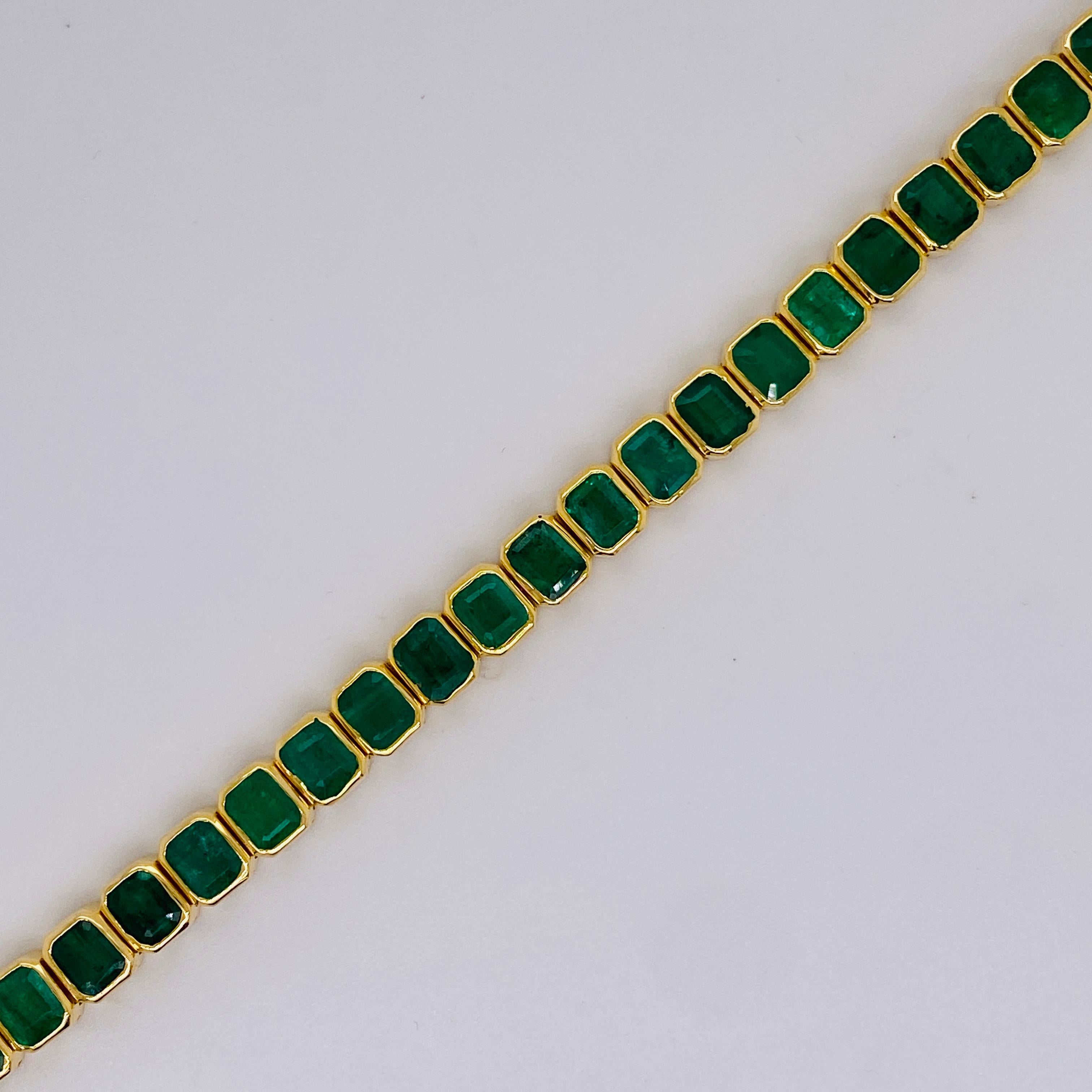 Make your bracelet as bold as you with this stunning emerald tennis bracelet. Each emerald is set in a gorgeous cut corner bezel link allowing it to gracefully wrap around your wrist. 
The green color of emeralds draw you in as if you were walking