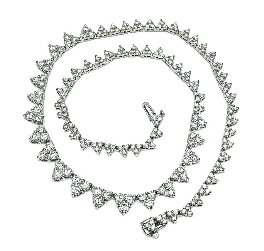 This is a stunning 18k white gold necklace. The necklace is set with sparkling round cut diamonds that weigh approximately 10.50ct. The color of these diamonds is G with VS clarity. The necklace has a tapering width from 4mm to 7.5mm. The necklace