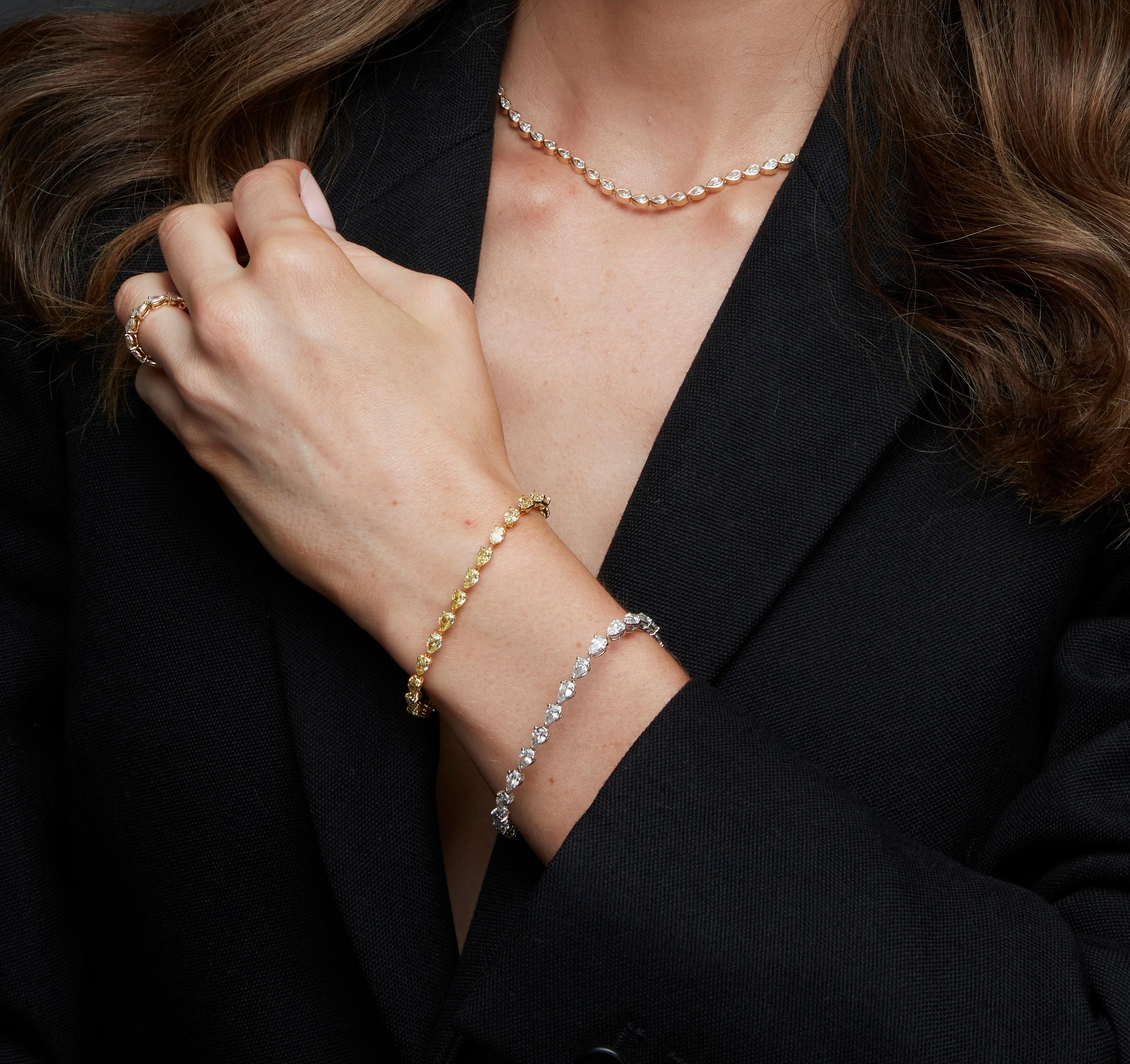 This exquisite pear-shaped diamond tennis bracelet is a true showstopper. Crafted in 18K white gold, it features 25 meticulously selected 0.40ct pear-cut diamonds totaling over 10.50 carats. Each stone is expertly set to maximize brilliance,