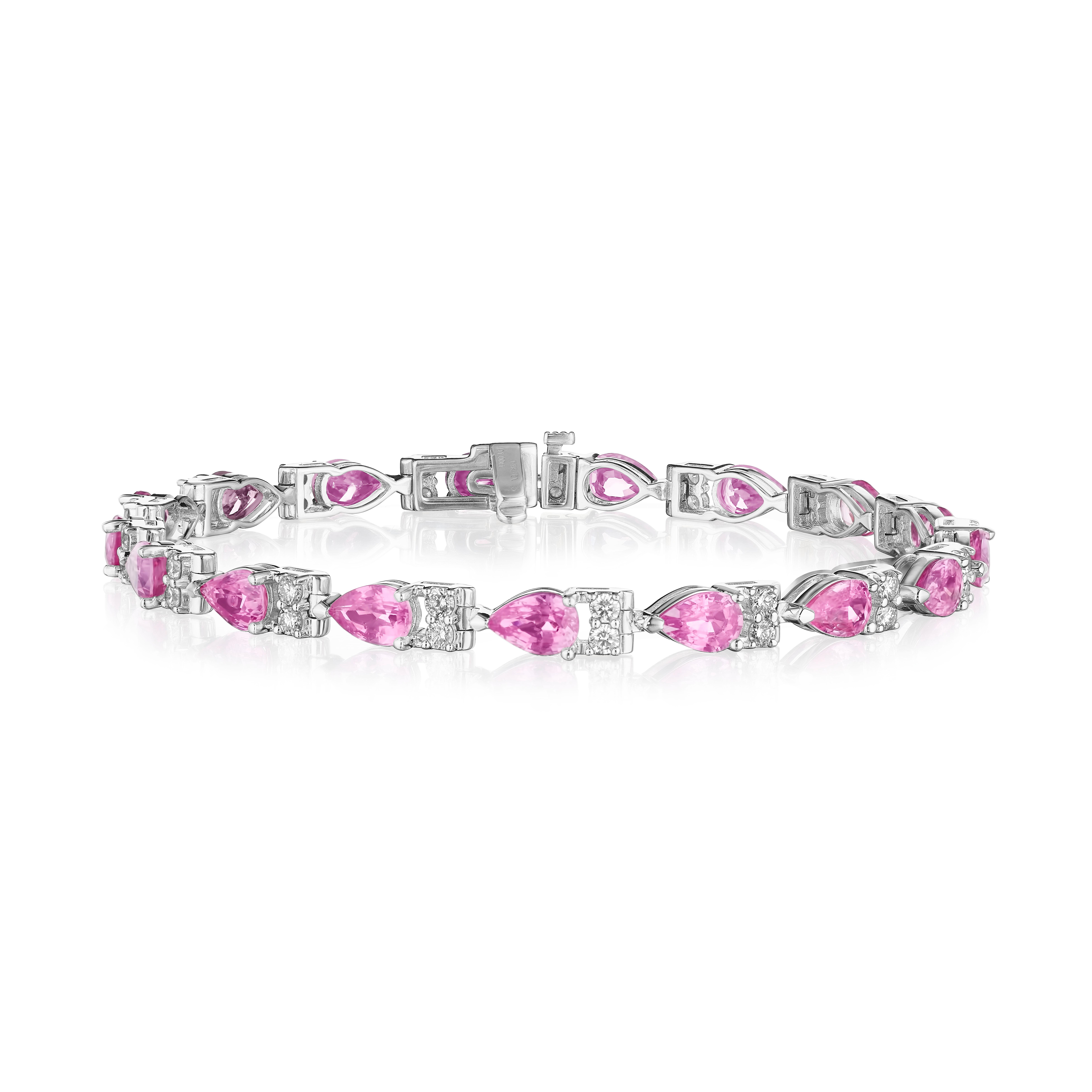 • A beautiful row of pink pear shape sapphires and white round brilliant cut diamonds encircle the wrist in this bracelet, set in 14KT gold. The bracelet measures 7