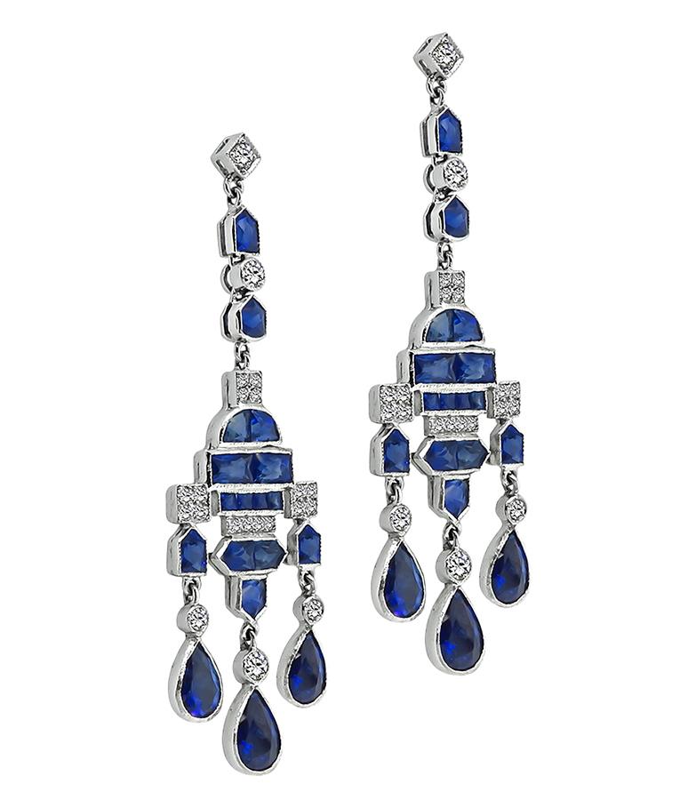 This is a gorgeous pair of 18k white gold earrings. The earrings feature lovely pear, pentagon, fan, square and rectangular cut sapphires that weigh approximately 10.50ct. The sapphires are accentuated by sparkling round cut diamonds that weigh