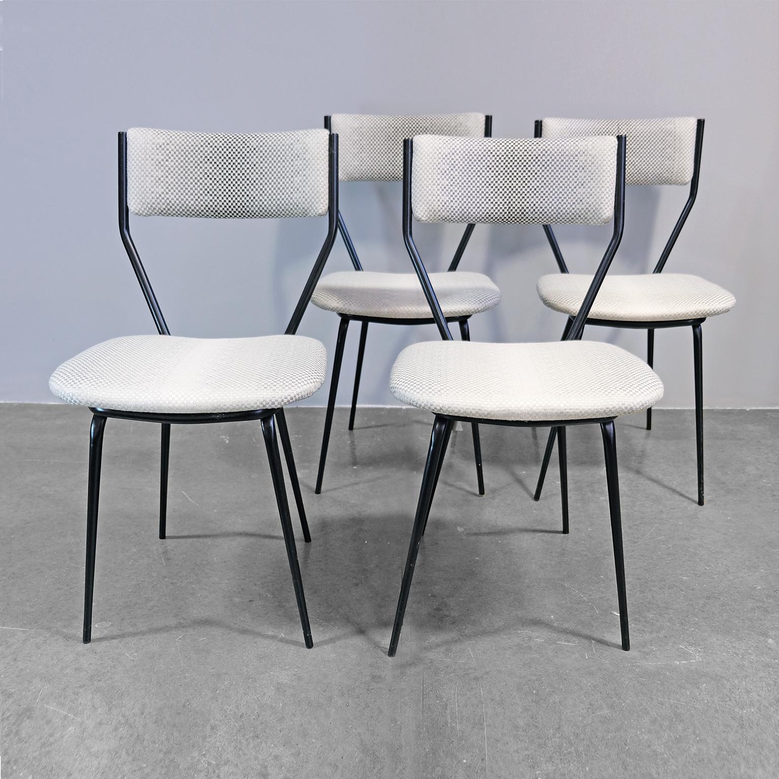 Set of four vintage dining chairs with structure in iron painted in black and seat and back with new upholstery. Made in 1950s and with a Portuguese origin, in Gio Ponti characteristic delicate design style. The iron legs made a discreet tapered