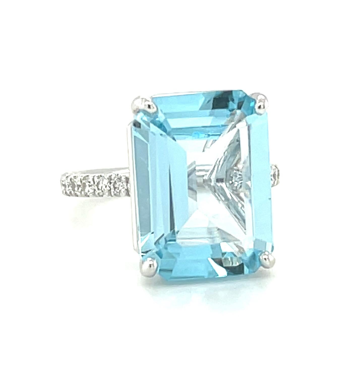This gorgeous platinum ring features a large, 10.51 carat, emerald-cut blue topaz with beautiful bright, sky blue color! 
24 sparkling diamonds weighing .50 carat total have been masterfully set by hand in the rounded band for a look that is