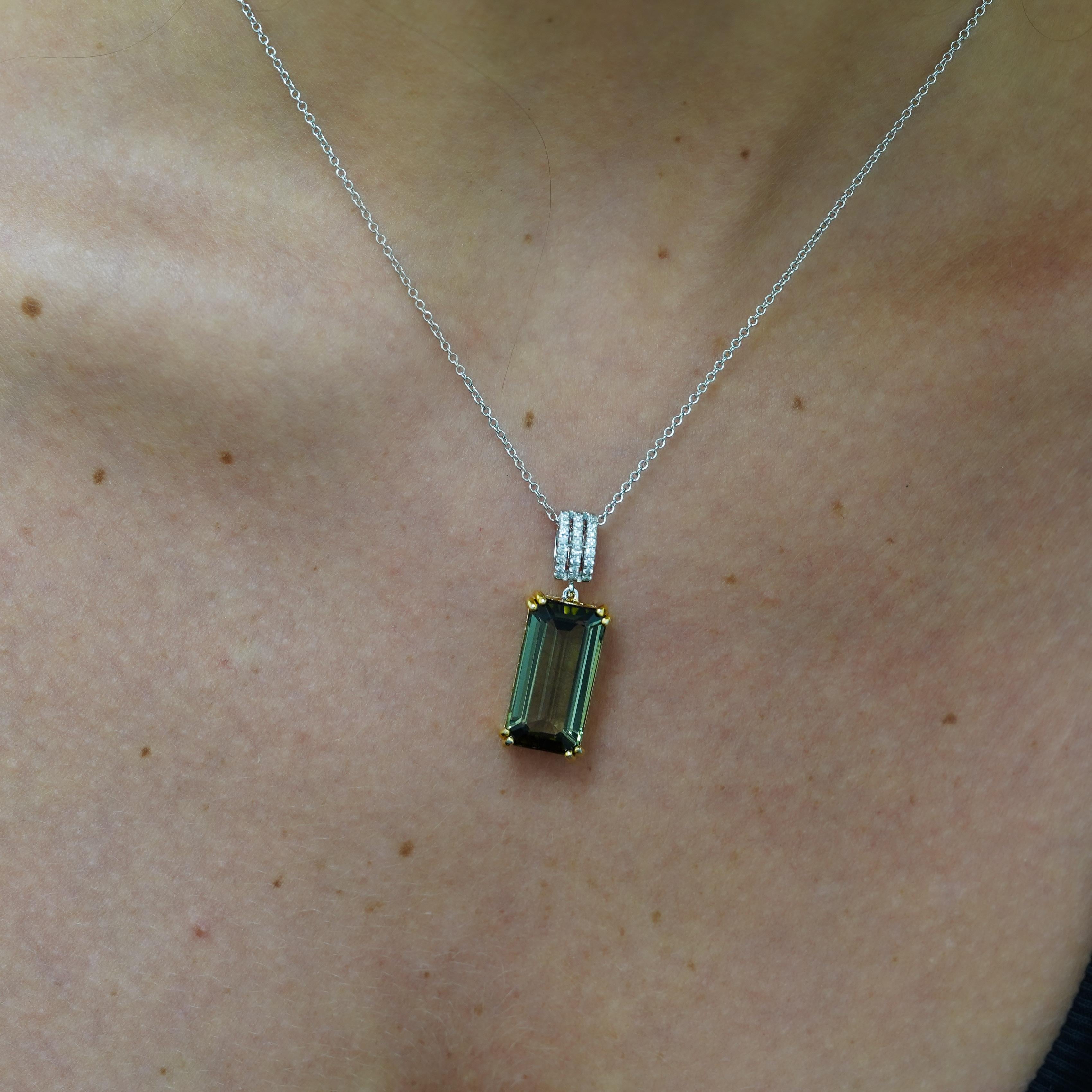 Natural 10.52 carat emerald cut forrest green tourmaline pendant in 18K white gold featuring 0.15 carat diamond accents with secure prong setting and matching chain. Exceptional green color with excellent clarity weighing 3.44 grams total.

Product