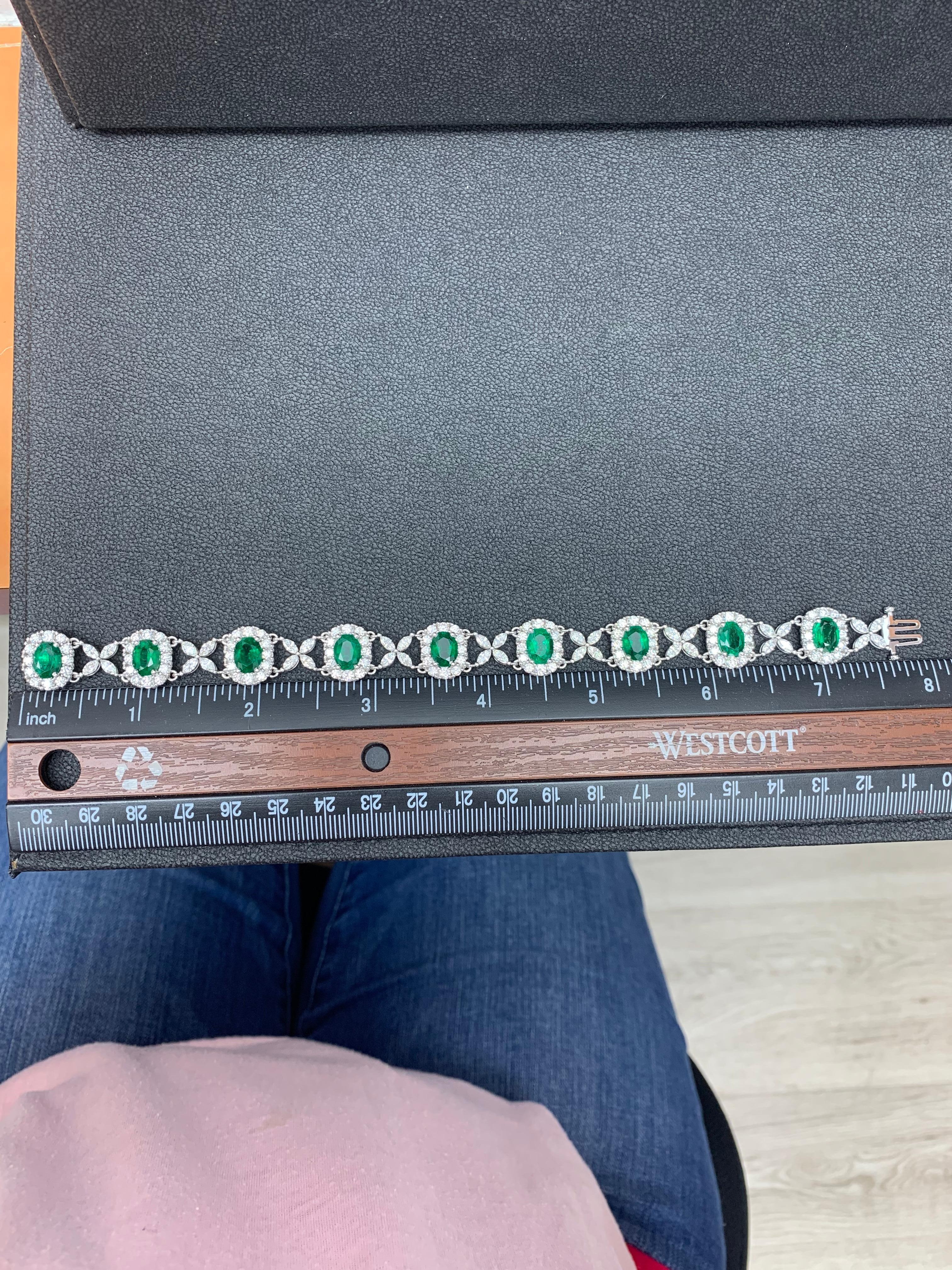 Gorgeous tennis bracelet set with 9 Emeralds surrounded by brilliant cut round diamonds. These Emeralds are linked with flower shape Marquise diamonds. Total weight of the emeralds is 10.52 carats; Total weight of the round diamonds is 1.36 carats