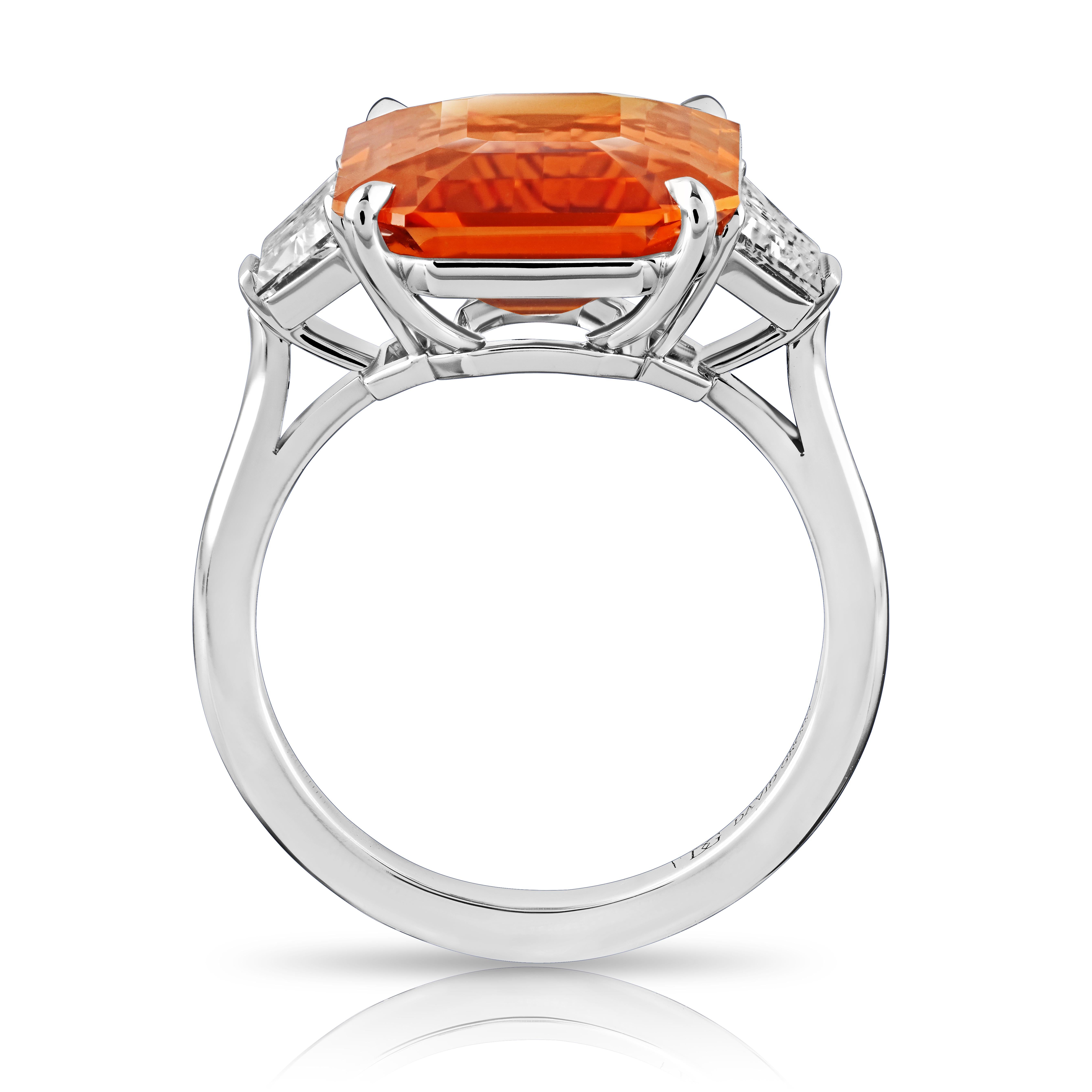 10.53 carat Emerald Cut Orange Sapphire with two Trapezoid Step Cut Diamonds 1.02 carats set in a handmade Platinum ring