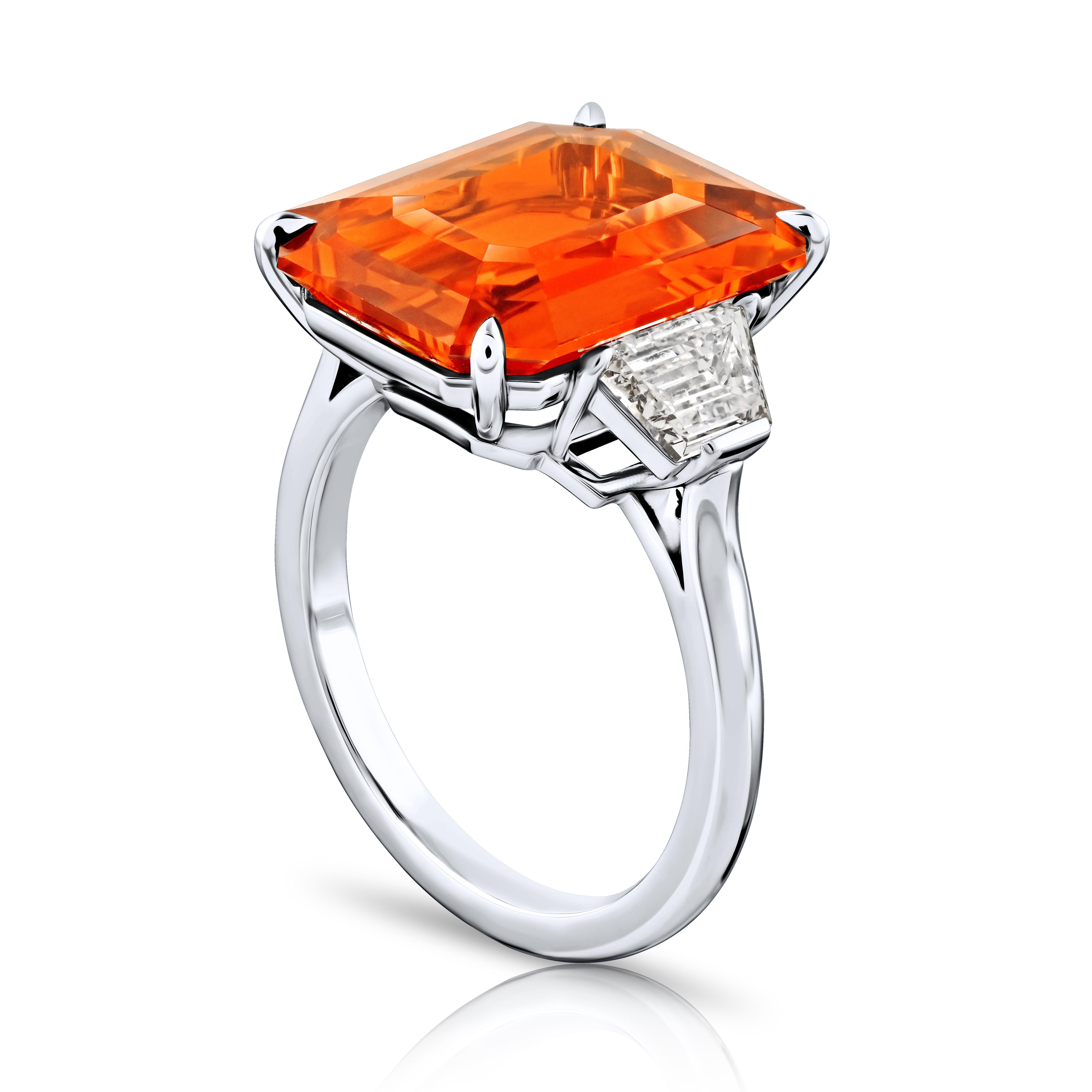 Contemporary 10.53 carat Emerald Cut Orange Sapphire with two Trapezoid Step Cut Diamonds in  For Sale