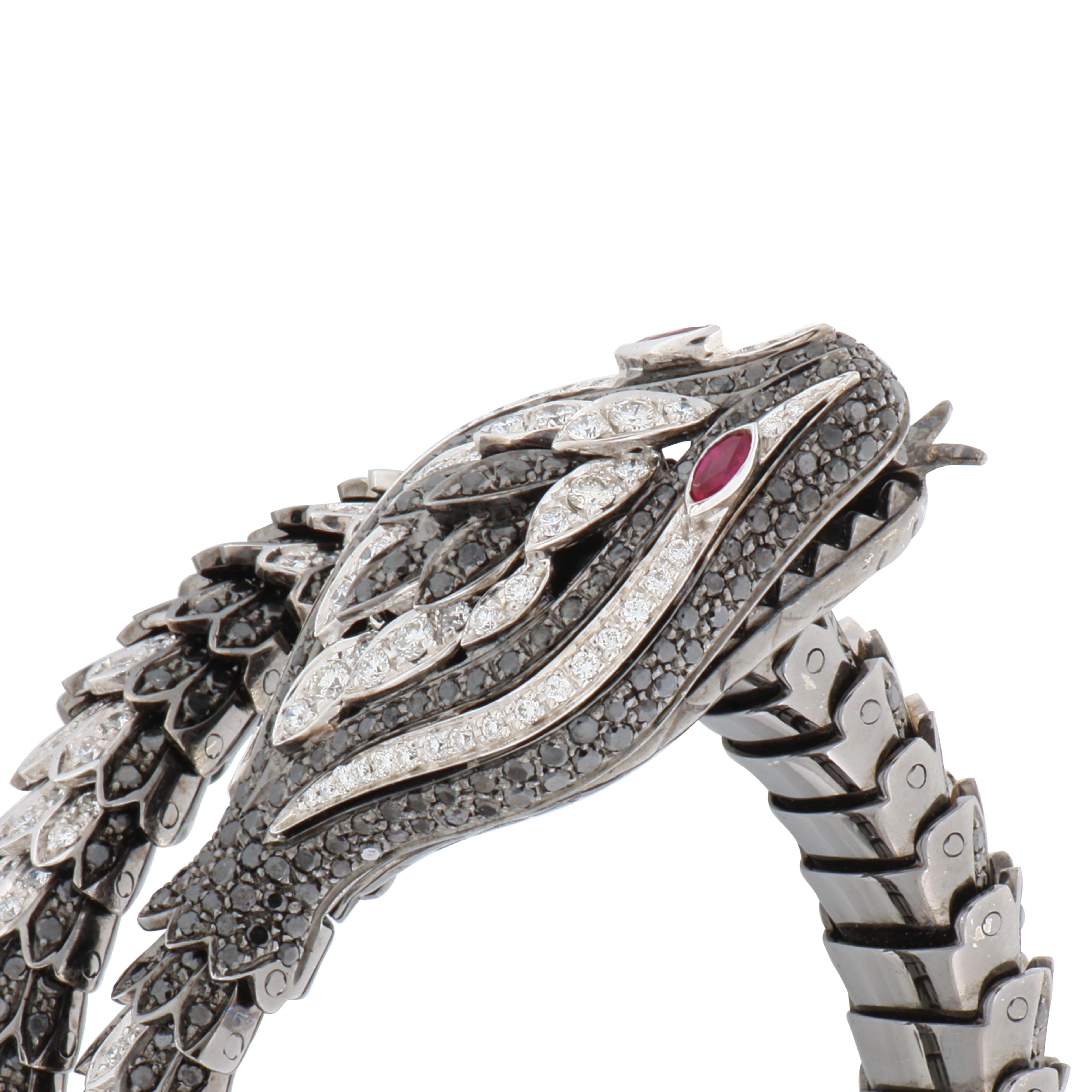 Snakes have always fasciated humans. This majestic animal is a symbol of good omen, power and rebirth.
This 18kt snake bracelet feature 3.04ct of white diamonds, 7.5 ct of black diamonds and 0.15ct of rubies.

Handcrafted by some of the most skilled