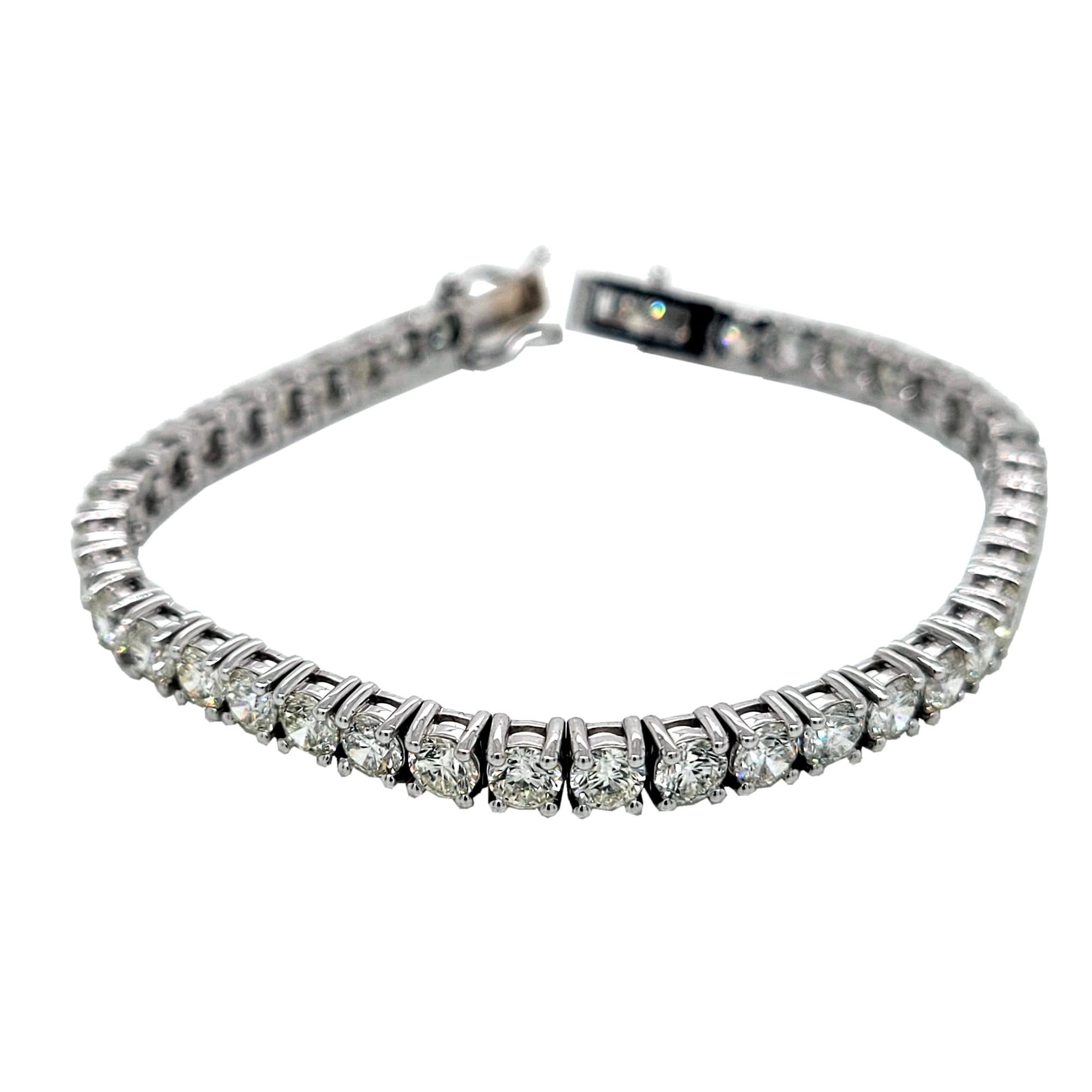 This Diamond Tennis Bracelet consists of 42 Links of 4-Prong Set 4.00 mm (1/4 Ct) Perfectly matched Round Brilliant diamonds set in 14K White Gold.   The bracelet comes with a  Built-In Safety Lock and double safety catch to protect it from loss.