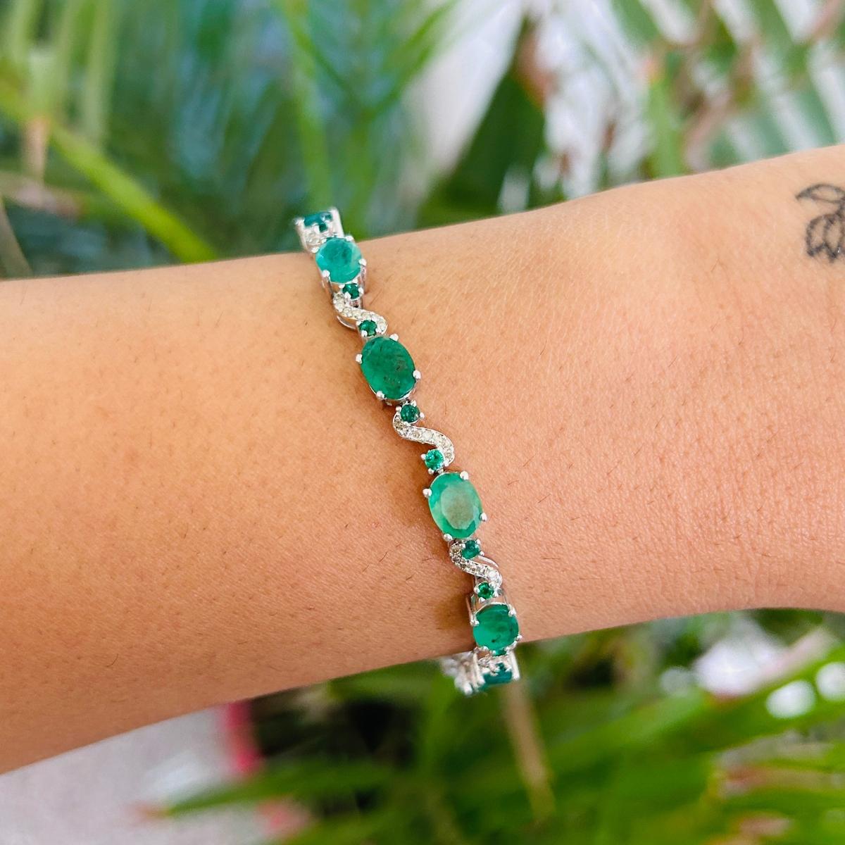 10.56 Carat Emerald Diamond Tennis Bracelet in Sterling Silver showcases endlessly sparkling natural emerald, weighing 10.56 carat and diamonds weighing 0.30carats. It measures 7 inches long in length. 
Emerald improves mental strength.
Designed