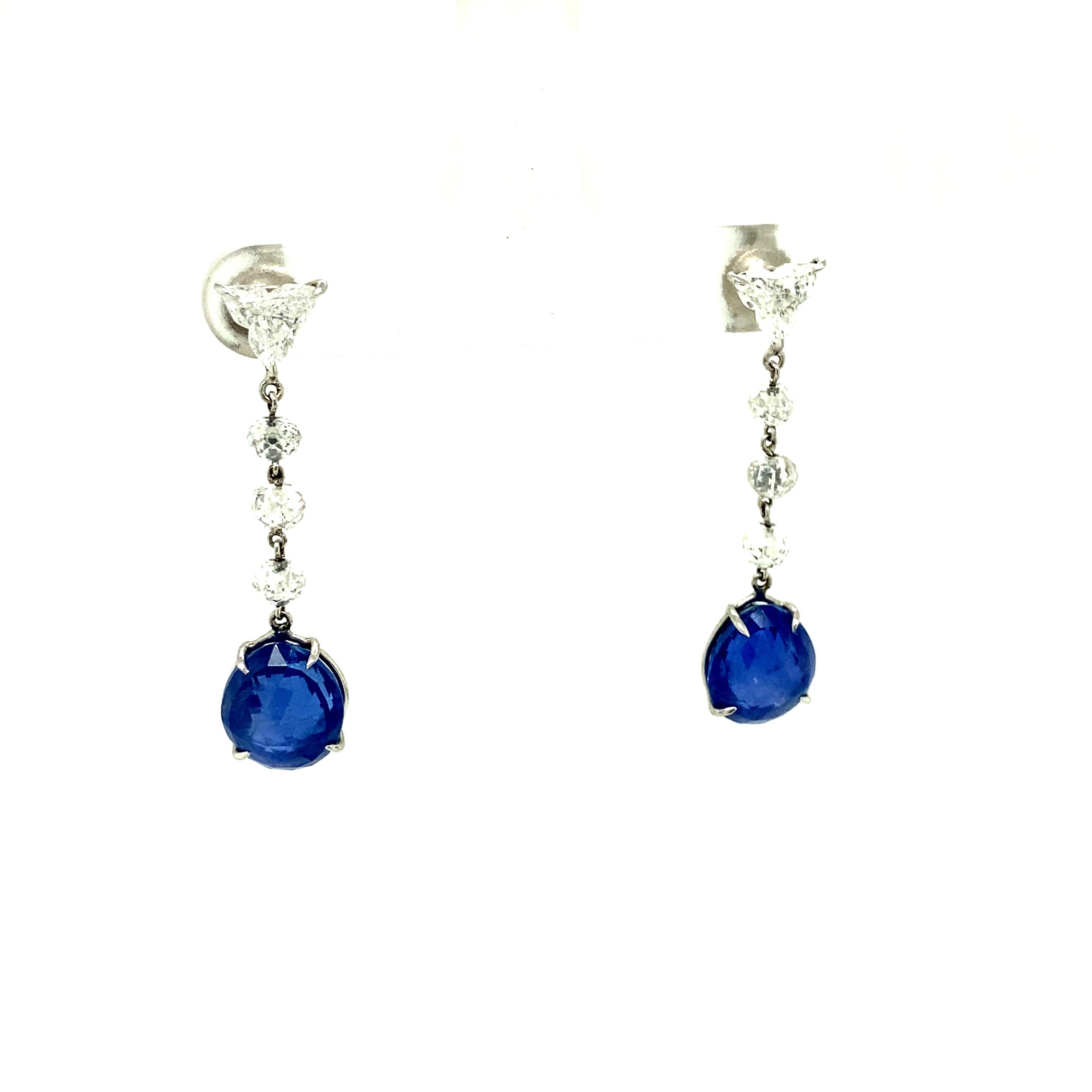 10.56 Carat GRS Certified Unheated Blue Sapphires and White Diamond Earrings:

A gorgeous pair of earrings, it features two unheated blue sapphire briolettes weighing 10.56 carat, with six white diamond beads and two fancy cut white diamonds