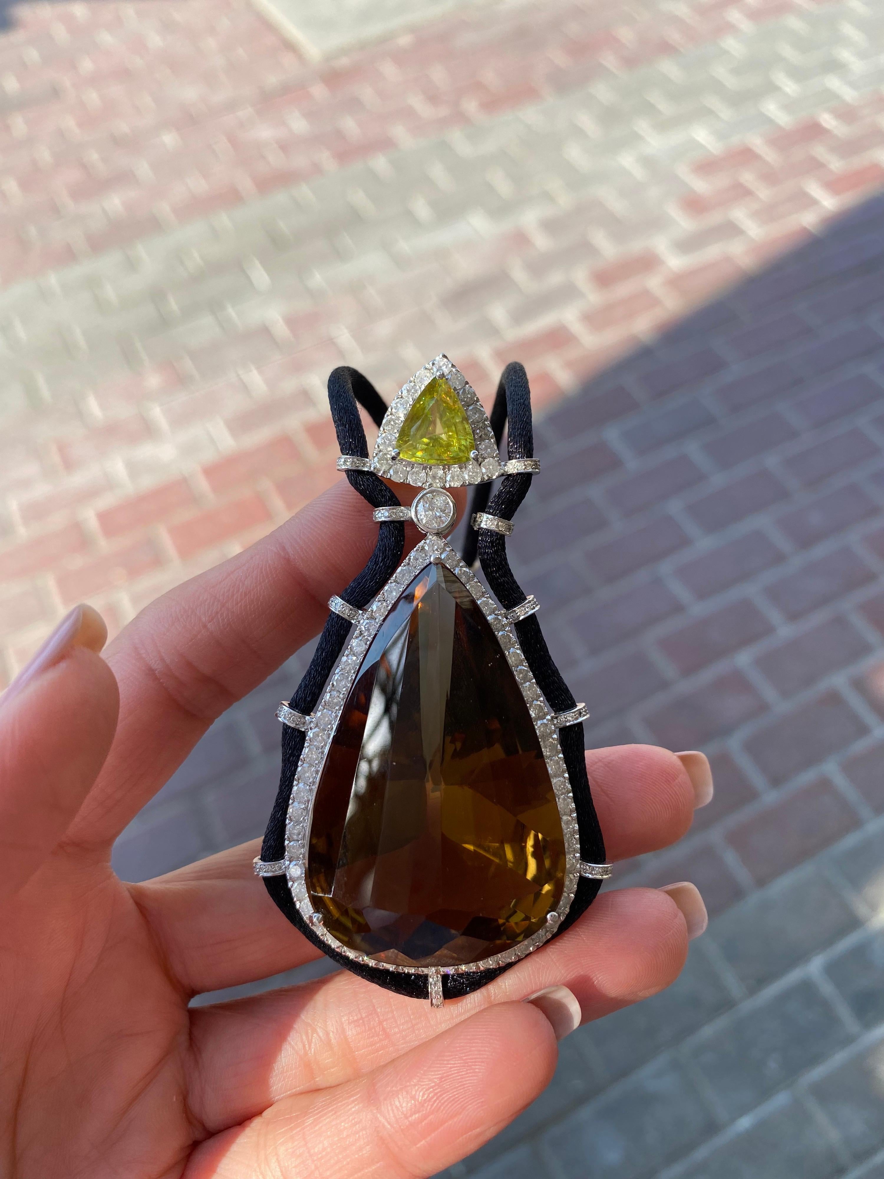 An art-deco necklace, with a 105.61 carat pear shaped Smoky Quartz, 3.08 carat Peridot and Diamonds. The smoky quartz and peridot has no inclusions at all, absolutely transparent with a great cut and luster., and the stones are set in Gold-plated