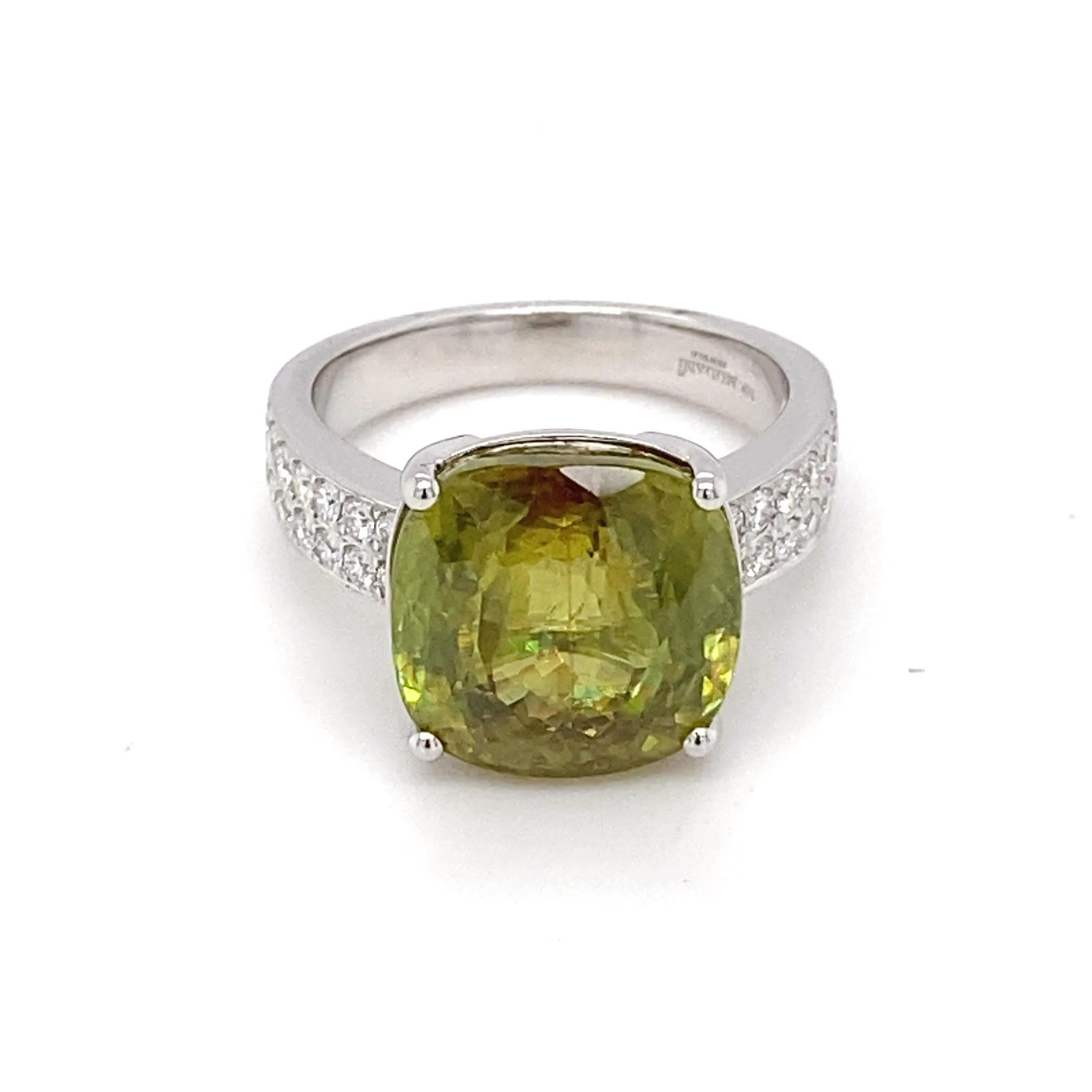 This 10.59 Carat cushion cut Sphene is set in white gold with four prongs and has accent diamond on the band. This ring is a minimalist elegance and ideal for daily wear. Sphene has more dispersion than diamond.
Sphene: 10.59 carat
Diamond: 0.51