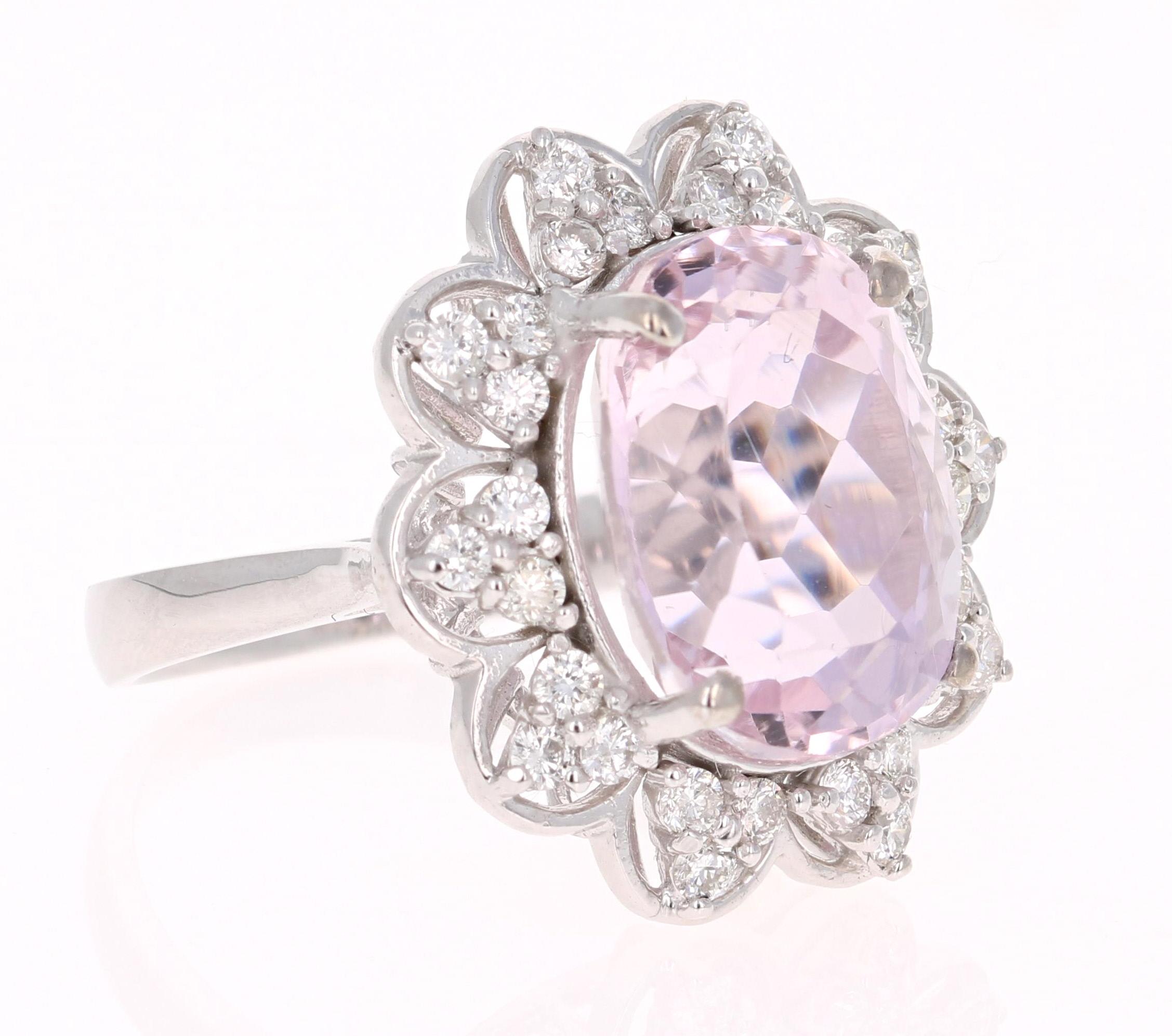 A beautiful Kunzite Ring resembling a fresh dainty flower. This gorgeous Kunzite Diamond Ring has a 9.85 Carat Oval Cut Kunzite as its center and is surrounded by 30 Round Cut Diamonds that weigh 0.74 carats. The total carat weight of the ring is