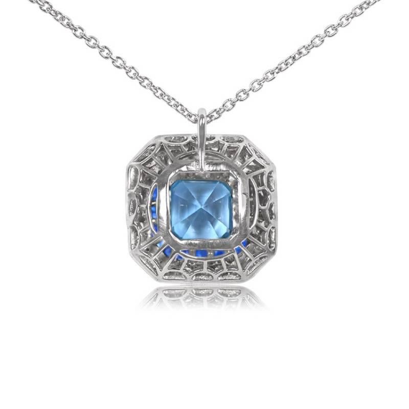 Presenting an exquisite platinum pendant showcasing a bezel-set, natural Asscher-cut aquamarine weighing 1.05 carats. Encircling the center stone are halos of meticulously calibrated French-cut sapphires and round brilliant-cut diamonds, accentuated