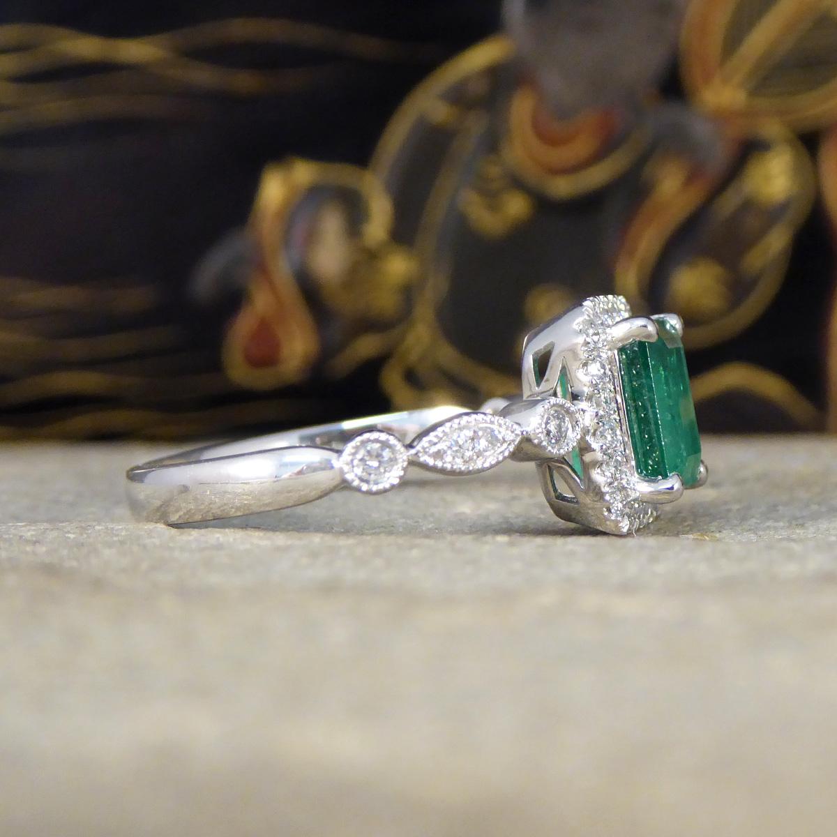 Edwardian 1.05ct Emerald and Diamond Cluster Ring with Diamond Shoulders in Platinum For Sale
