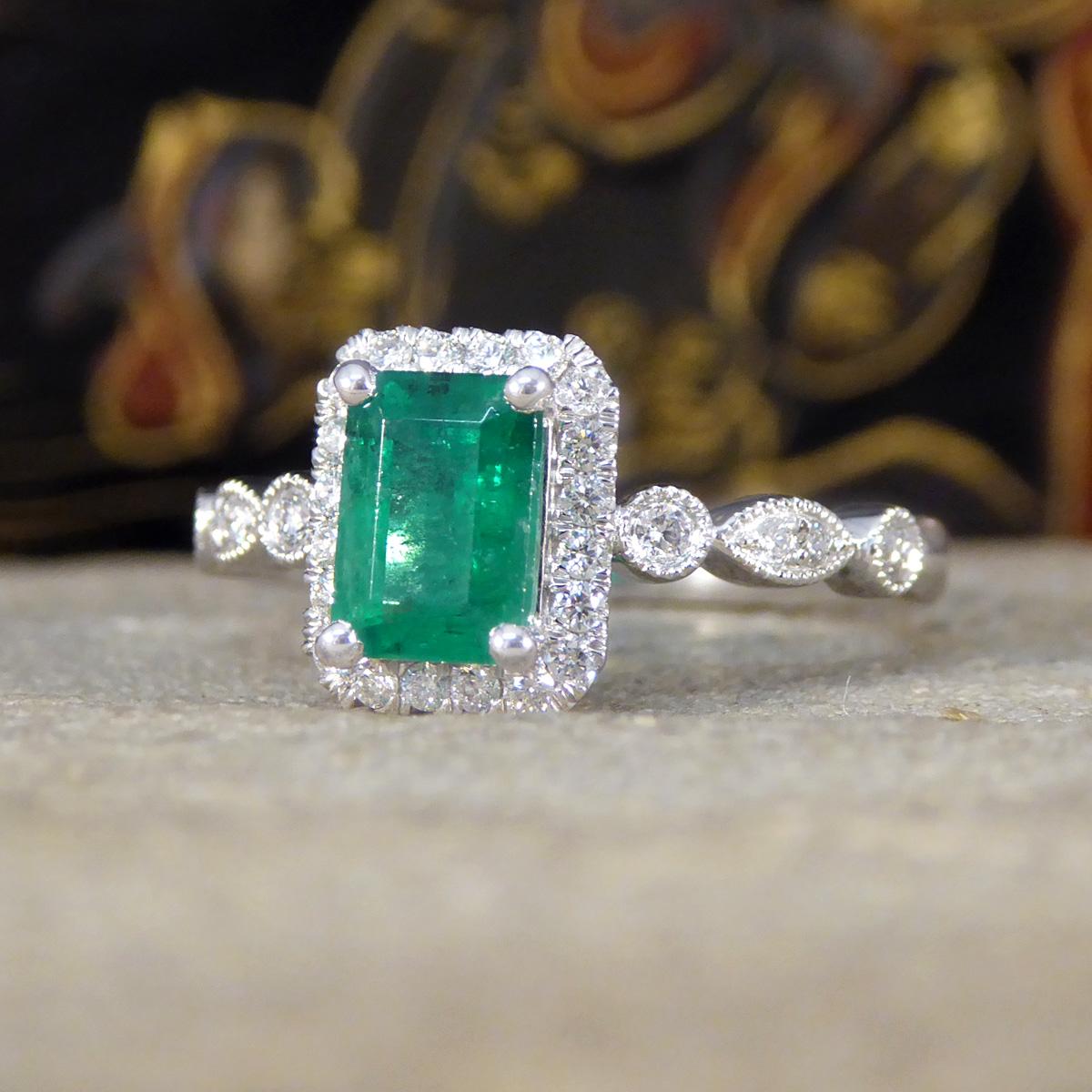 1.05ct Emerald and Diamond Cluster Ring with Diamond Shoulders in Platinum In New Condition For Sale In Yorkshire, West Yorkshire