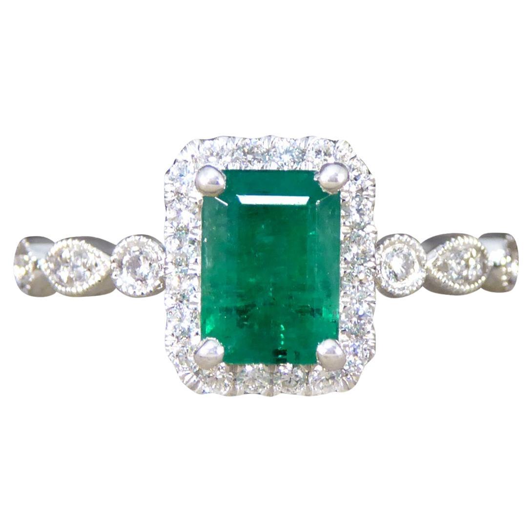 1.05ct Emerald and Diamond Cluster Ring with Diamond Shoulders in Platinum For Sale