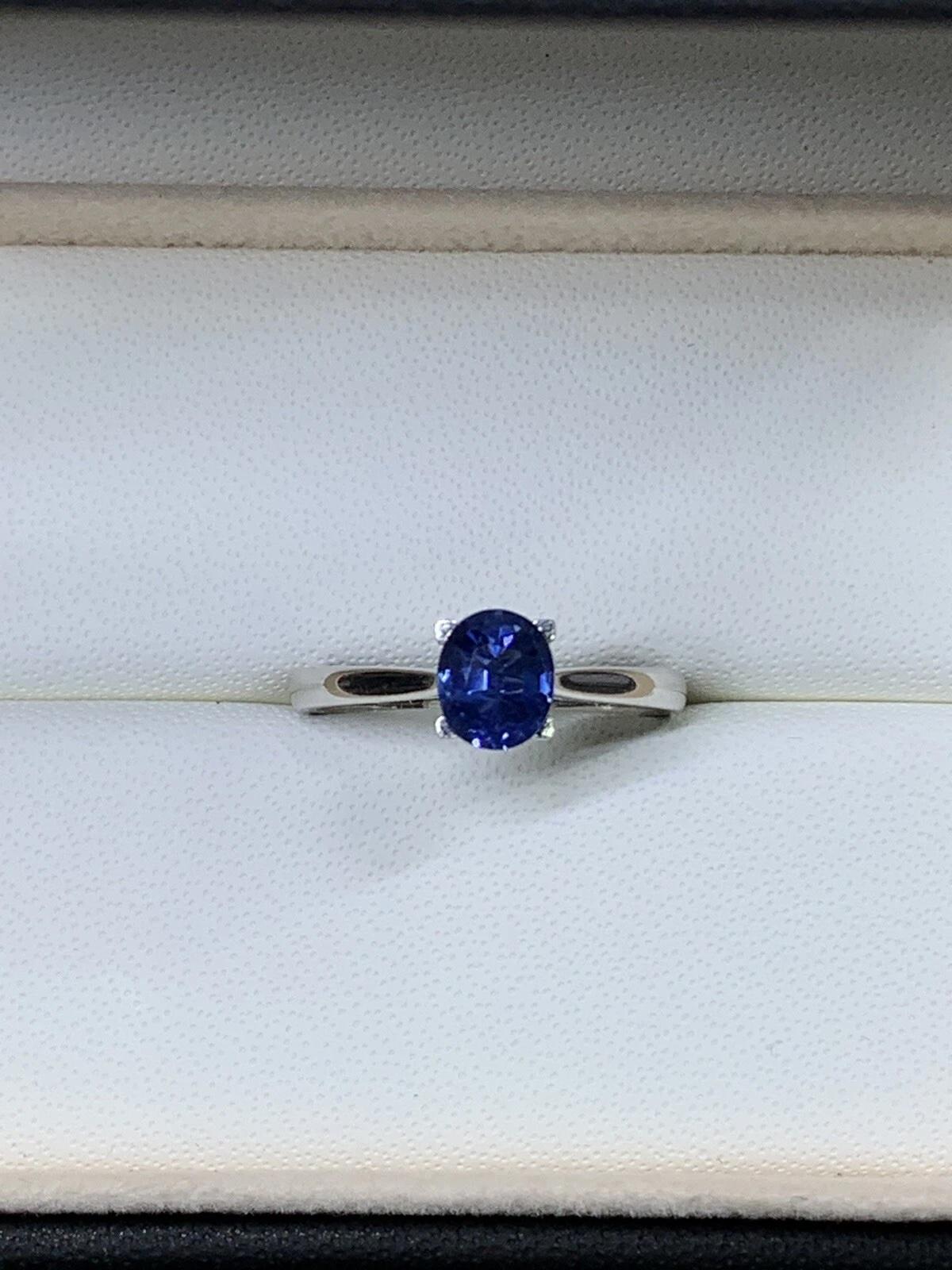 This stunning engagement ring features a 1.05ct natural oval-shaped sapphire in a beautiful royal blue colour, set in 18ct white gold. The solitaire setting style showcases the beauty of the sapphire, making it a perfect choice for a special
