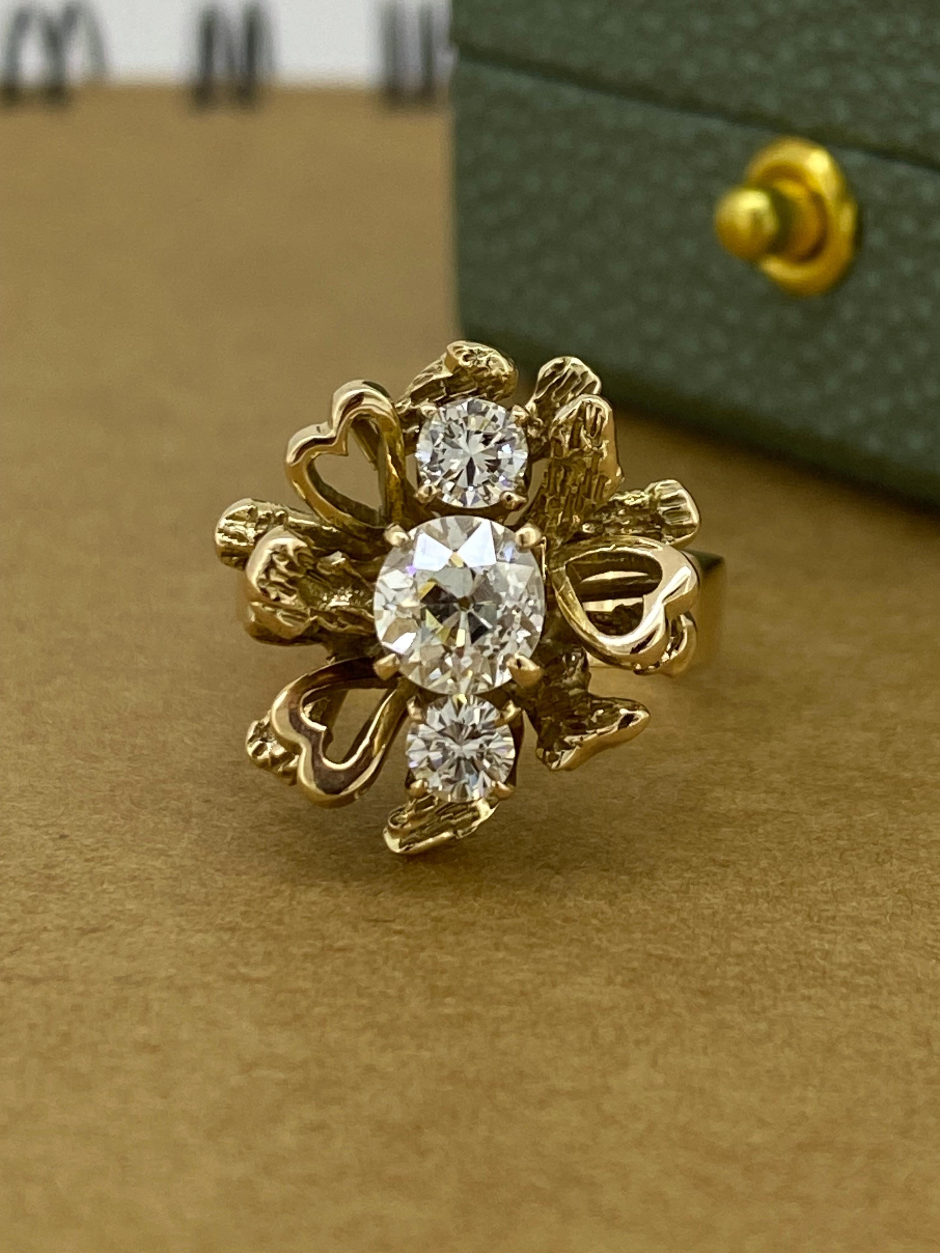 This visually striking English retro piece of jewellery is
is crafted in 14K Rose Gold
with remarkable attention to details:

Designed as a flowerhead, 
centering a vertical cluster of old-European cut & 
transitional cut diamonds: 

Center stone: