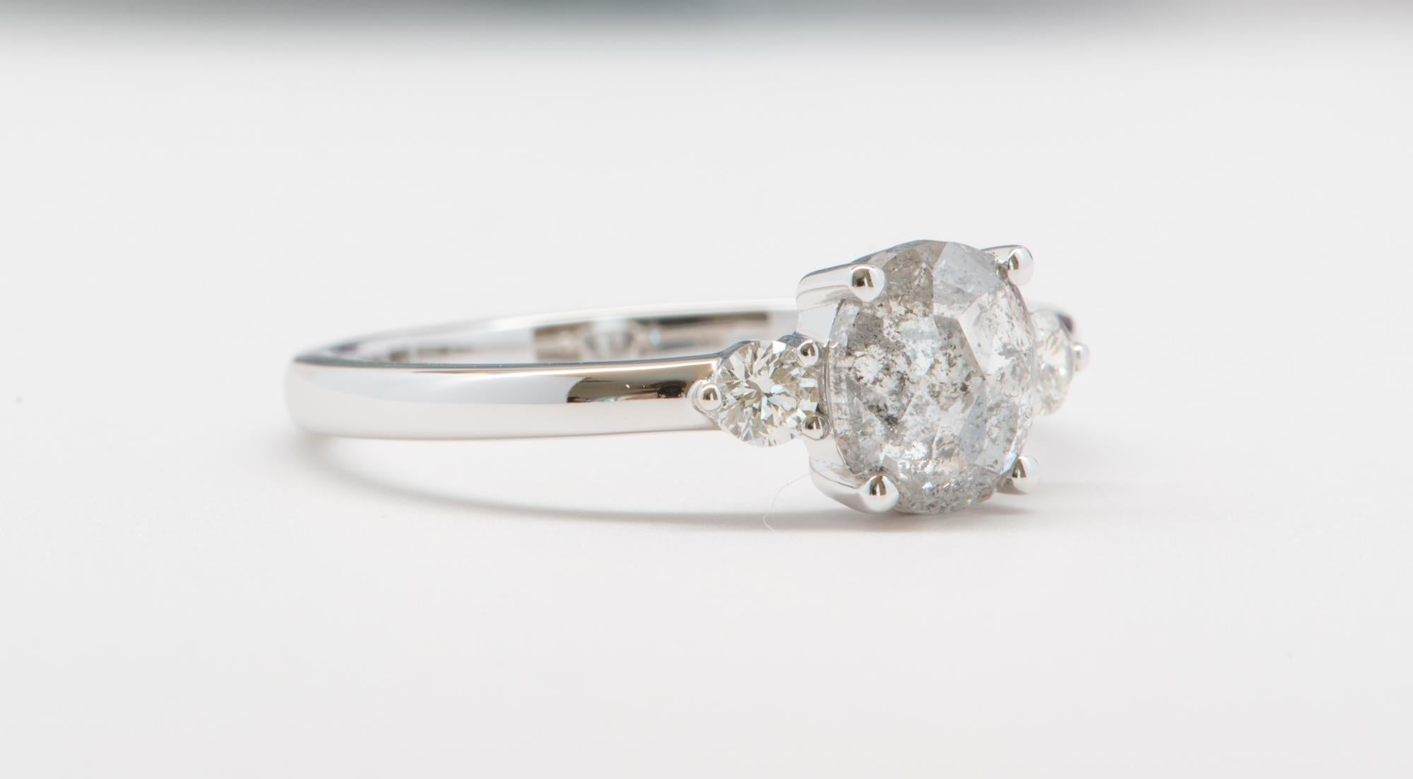 ♥  A solid 14k white gold ring featuring an oval-shaped salt and pepper diamond in the center, flanked with two colorless diamonds on each side to complement the center stone
♥  The overall setting measures 11.8mm in width, 6.6mm in length, and sits