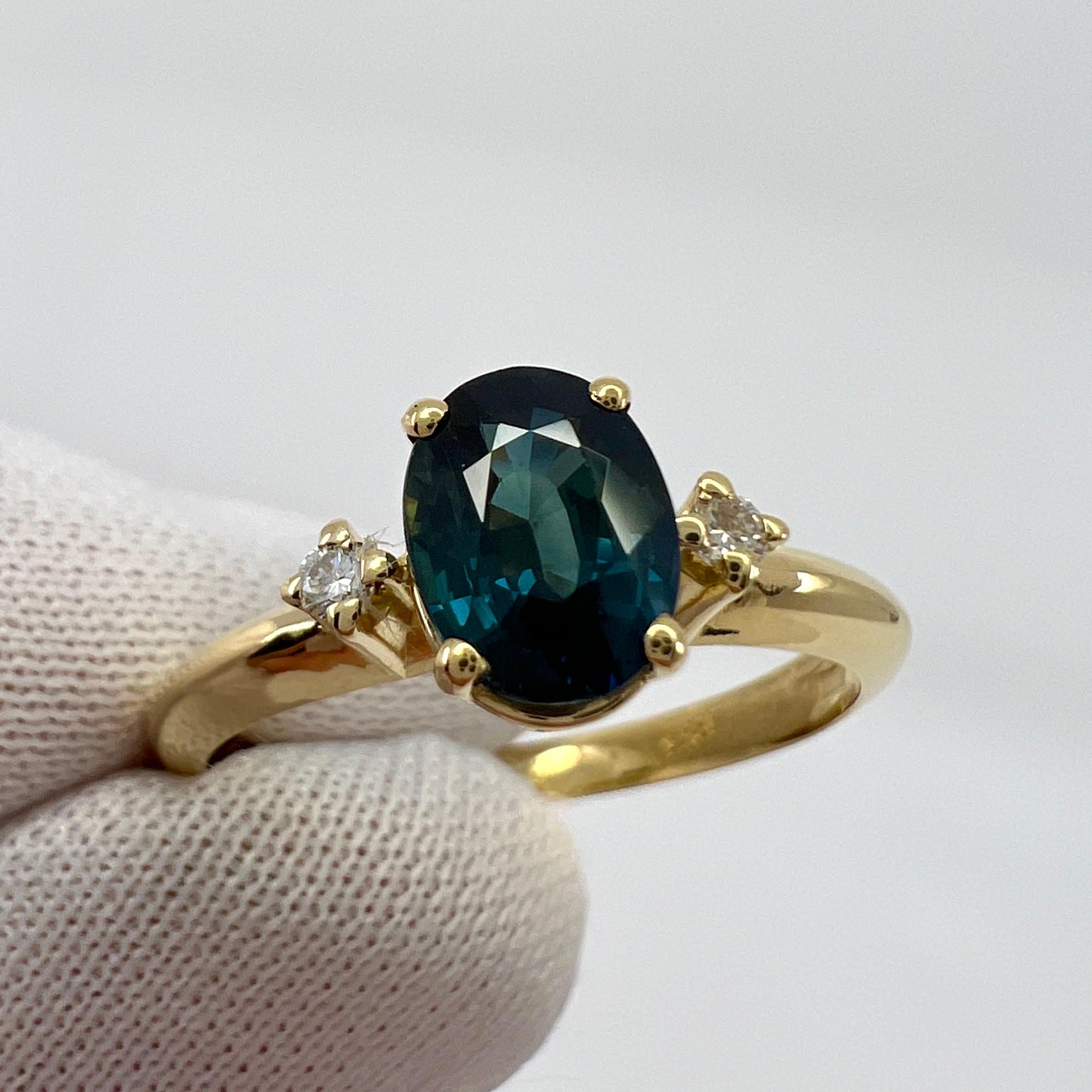 Natural Teal Green Blue Oval Cut Sapphire & Diamond Three Stone 18k Yellow Gold Ring

Fine teal green blue oval cut natural sapphire centre stone. 1.05 carat measuring just under 6.8x5mm. Excellent oval cut and very good clarity.
Accented by x2