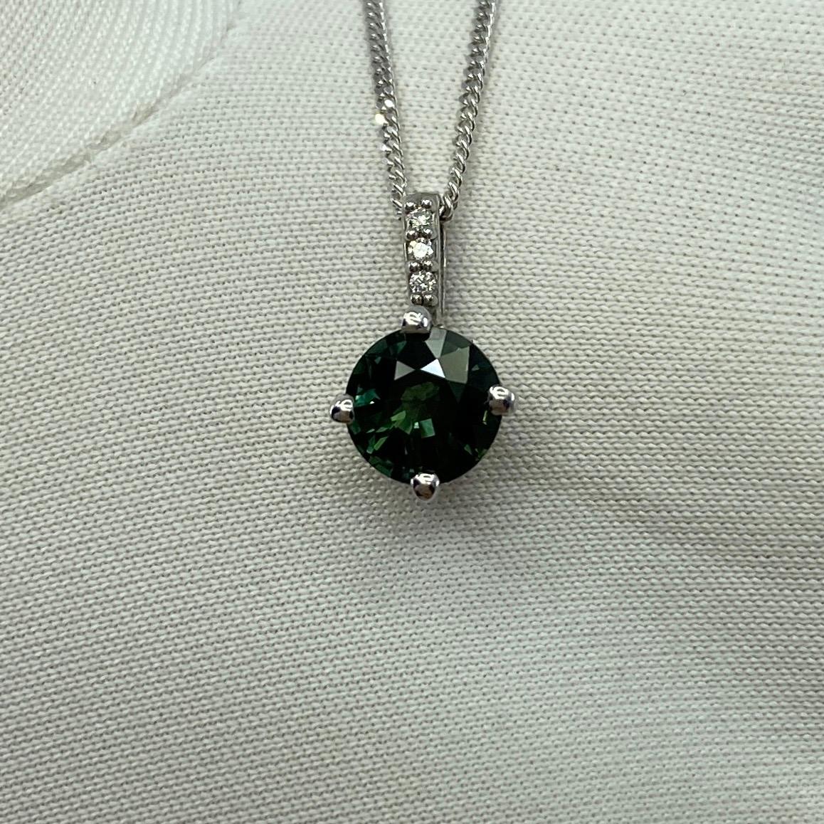 Untreated Green Blue Sapphire 18k White Gold Diamond Surround Set Pendant.

1.05 Carat sapphire with fine vivid green blue colour and excellent clarity. Also has an excellent round cut which displays the fine colour to best effect. Very bright and