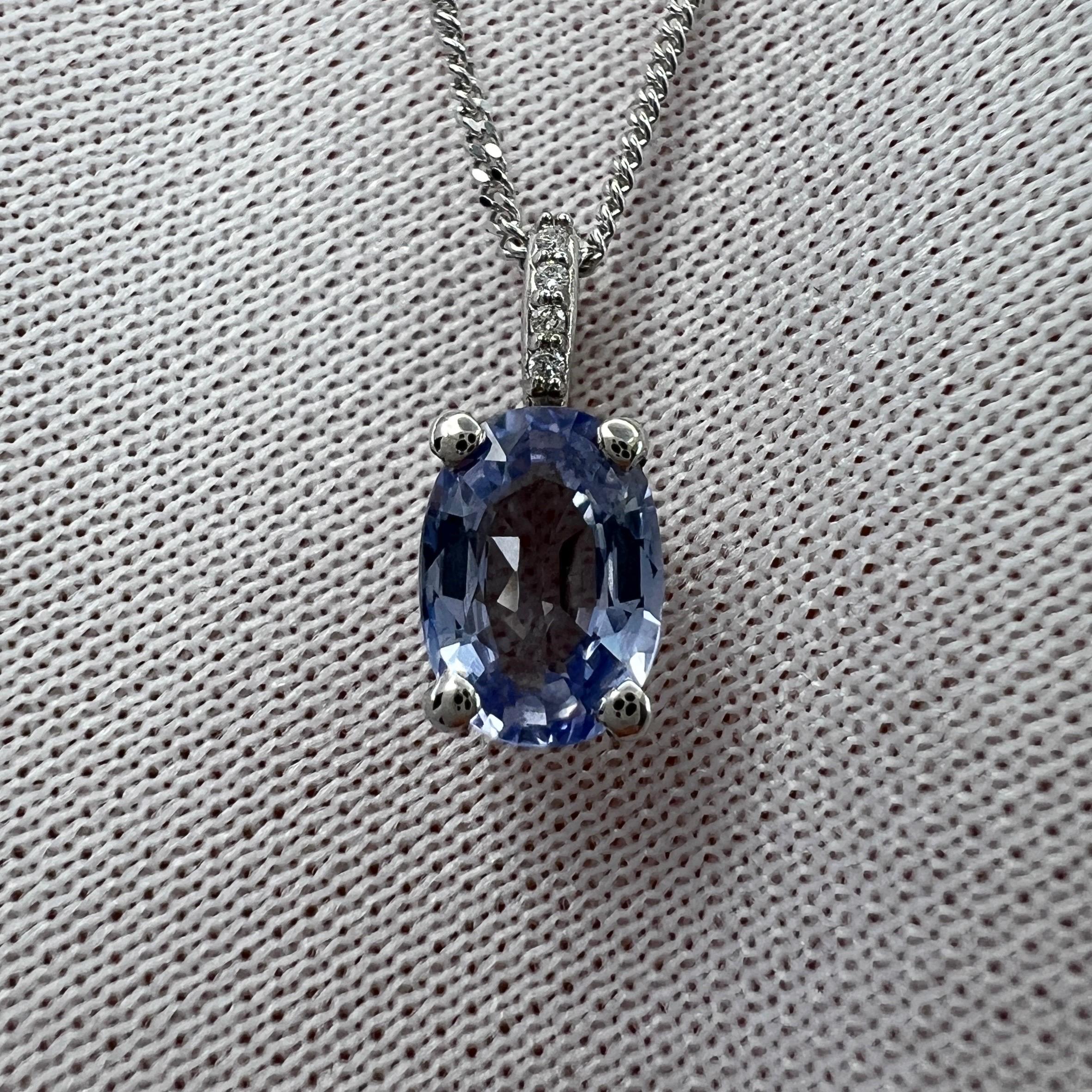 Natural Vivid Blue Ceylon Sapphire & Diamond 18k White Gold Hidden Halo Pendant Necklace.

1.05 Carat sapphire with a bright vivid blue colour and excellent clarity. A very clean stone, VVS.
Also with an excellent oval cut. Measures 7x5mm.

Sapphire