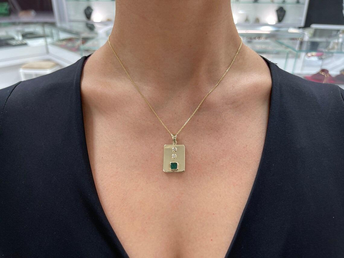 Captivate your eyes on this stunning, Colombian emerald and diamond pendant. The emerald has a full 1.0-carats of dark rare Muzo green color and excellent luster. Accenting the gorgeous emerald are two other brilliant round-cut diamonds. Carefully