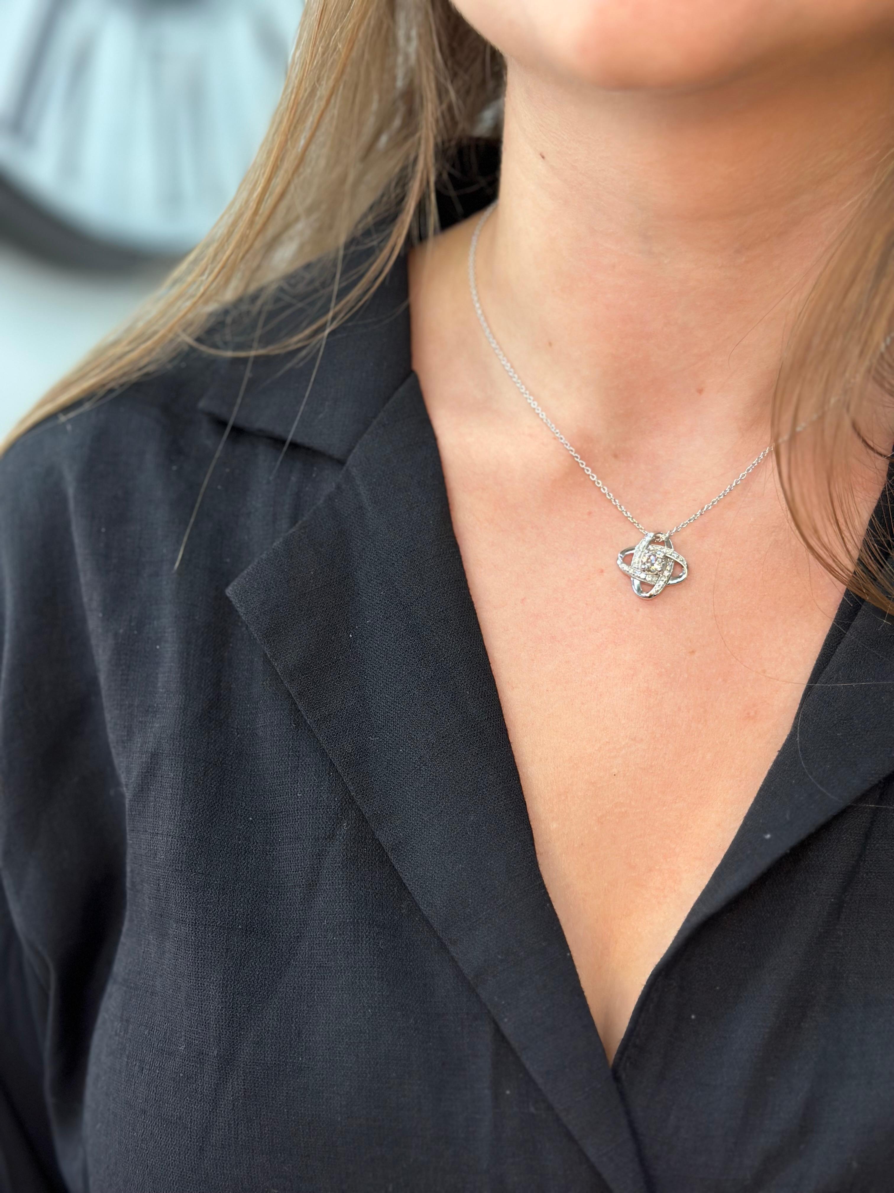 Introducing our stunning Infinity Diamond Solitaire Pendant in 14K White Gold! This pendant is designed to turn heads and leave a lasting impression. 

It features a .75 round-cut diamond center stone in an infinity knot design in 14K White Gold.