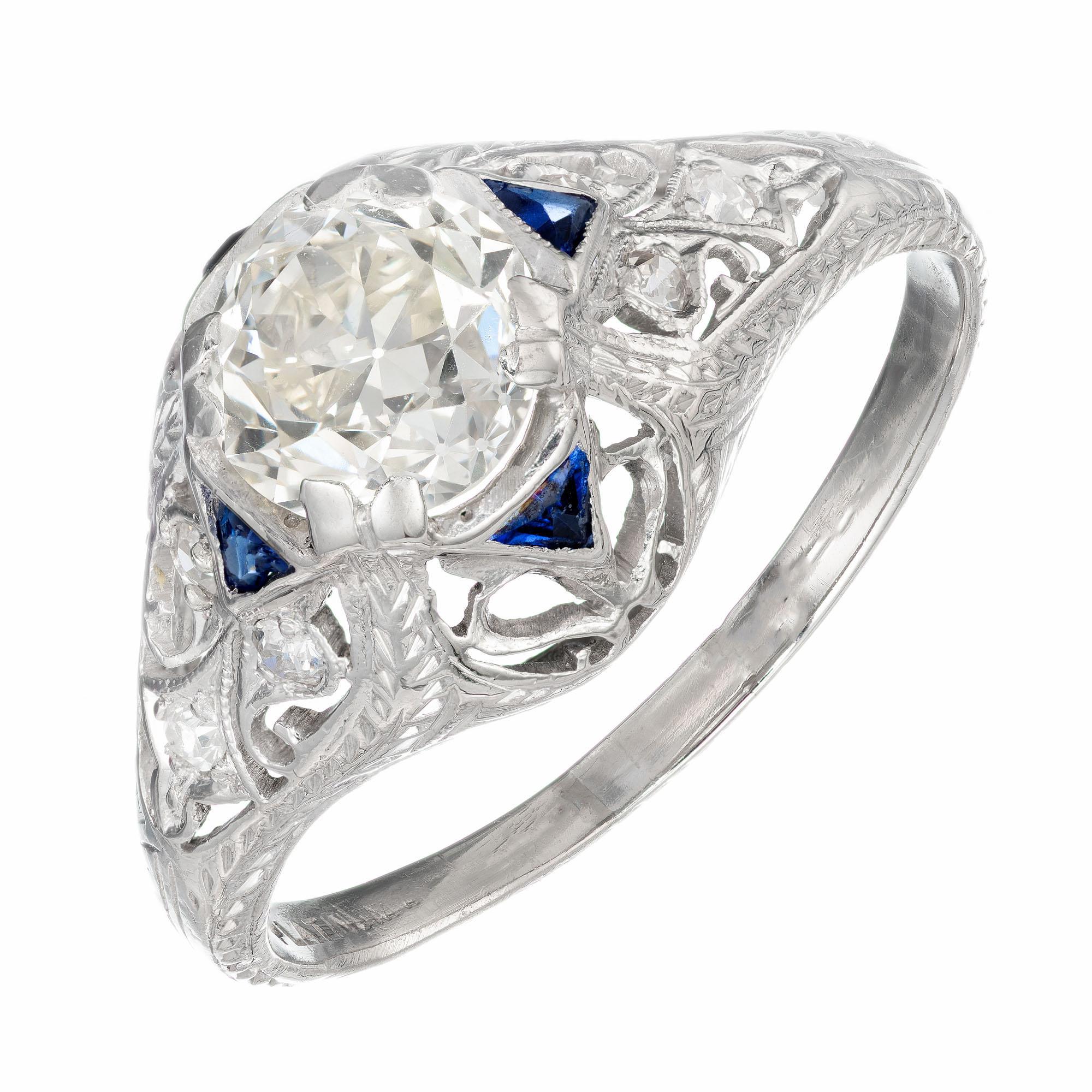 1890-1900 diamond engagement ring. EGL certified transitional cut diamond center stone with 6 round diamonds and 4 transitional cut sapphires in a handmade platinum setting.  Pierced and hand engraved with an original old cut diamond. Raised crown.