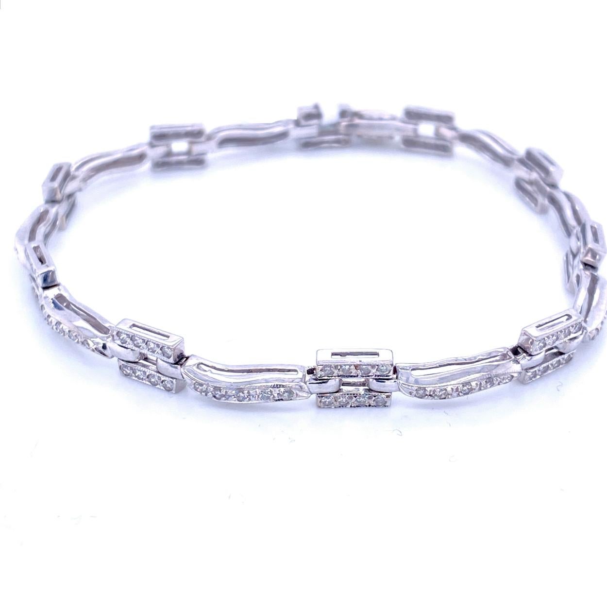 This Diamond Bracelet consists of 9 bar and 10 rectangular Links with Milgrained Edge Pave Set with 125 pieces of 1.1 mm Round Brilliant diamonds in 14K Gold.   The bracelet comes with a  Built-in safety lock to protect it from loss. 
Total Weight