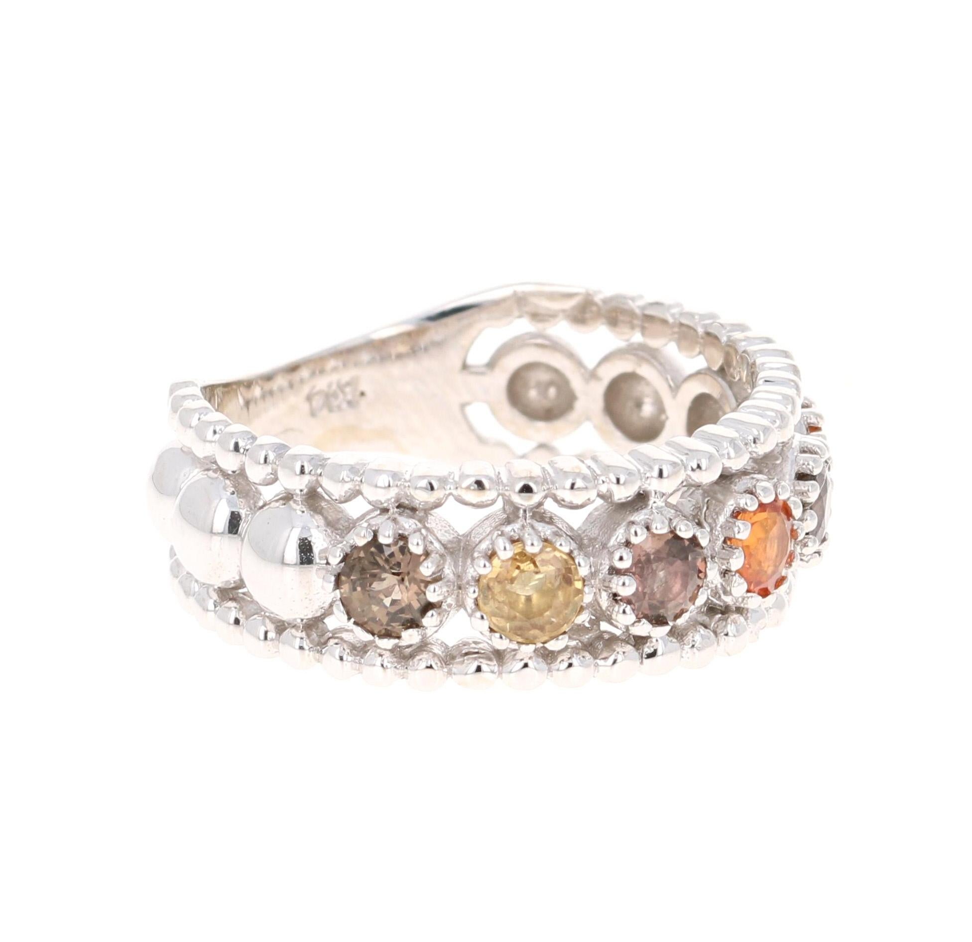 A Uniquely designed Multi Color Sapphire Band that is sure to be a great addition to your jewelry collection!  
This band has 6 Round Cut Multi-Colored Sapphires with hues of Yellow and Pink that weigh 1.06 carats.  

The ring is made in 14K White