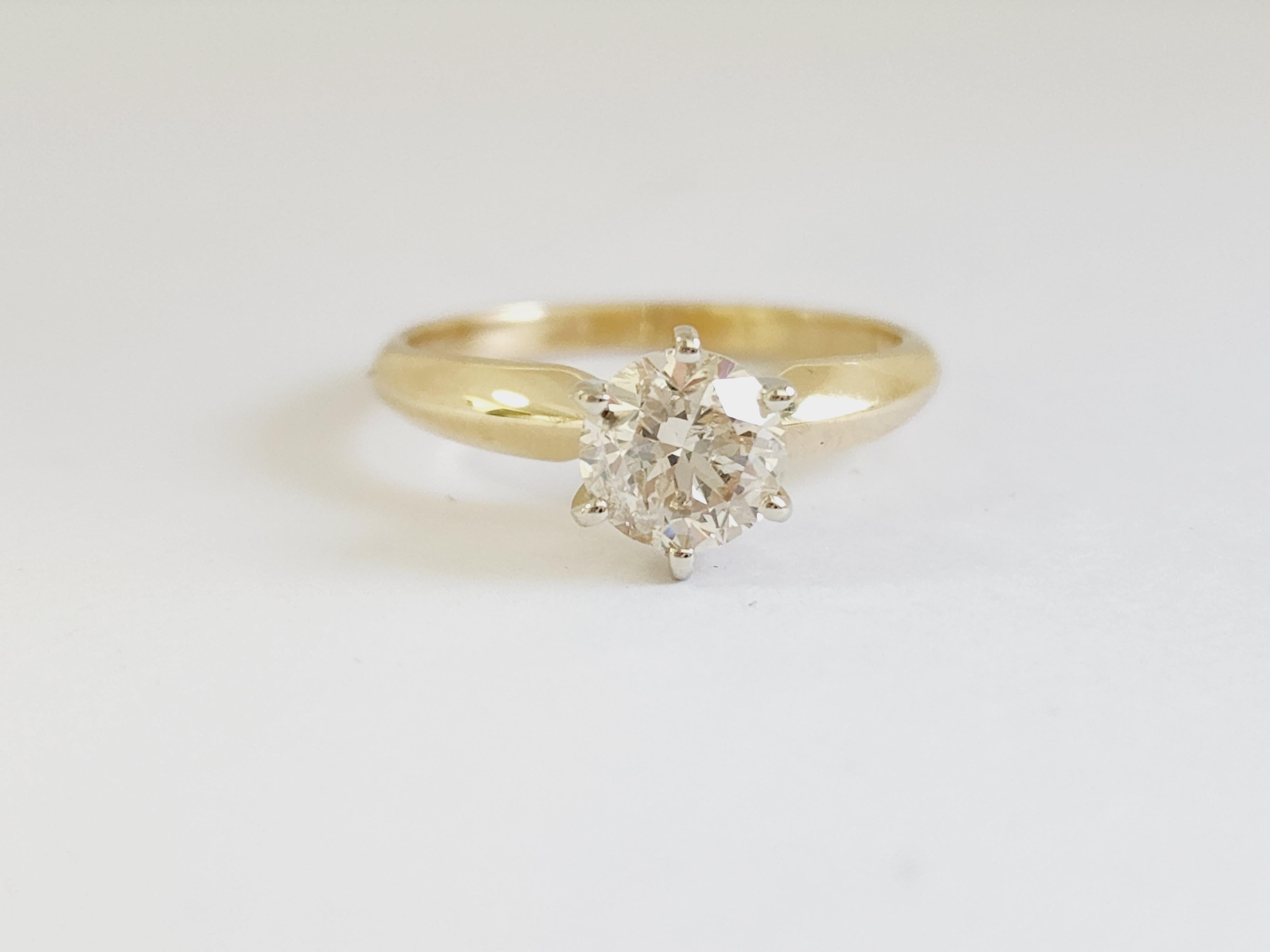 1.06 ct round brilliant cut natural diamonds. 6 prong solitaire setting, set in 14k yellow gold. Ring Size 7.
