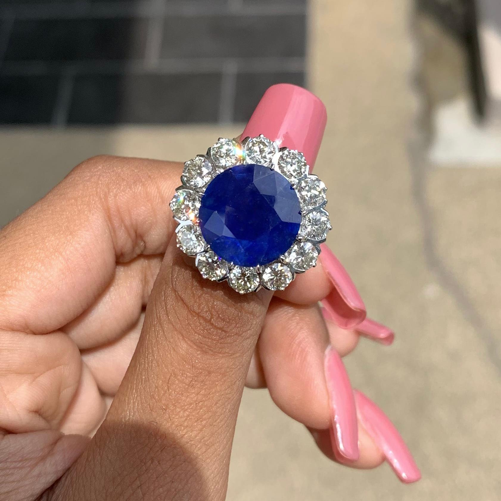 Presenting a true masterpiece of elegance and allure, this breathtaking statement Sapphire Ring! At the heart of this magnificent ring lies a breathtaking 10.60 carat sapphire. With its deep and alluring cornflower blue hue, the sapphire commands